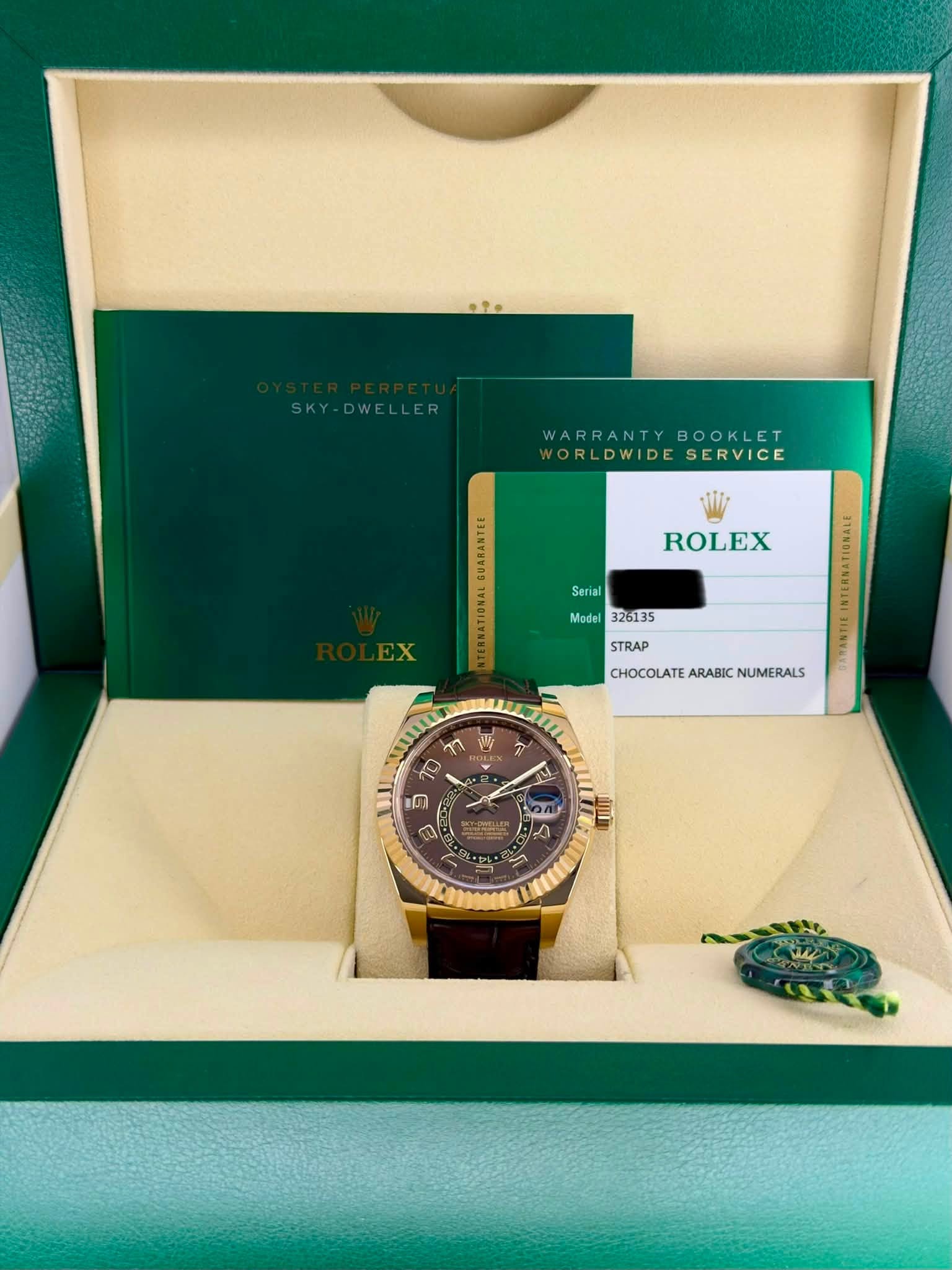 May be an image of wrist watch and text that says 'SKY-DWELLER SKY -DWELLER WARRANTY WARRANTYBOOKLET BOOKLET VORLDWIDESERVICE ORLDWIDE SERVICE ROLEX Serial Model 326135 STRAP…
