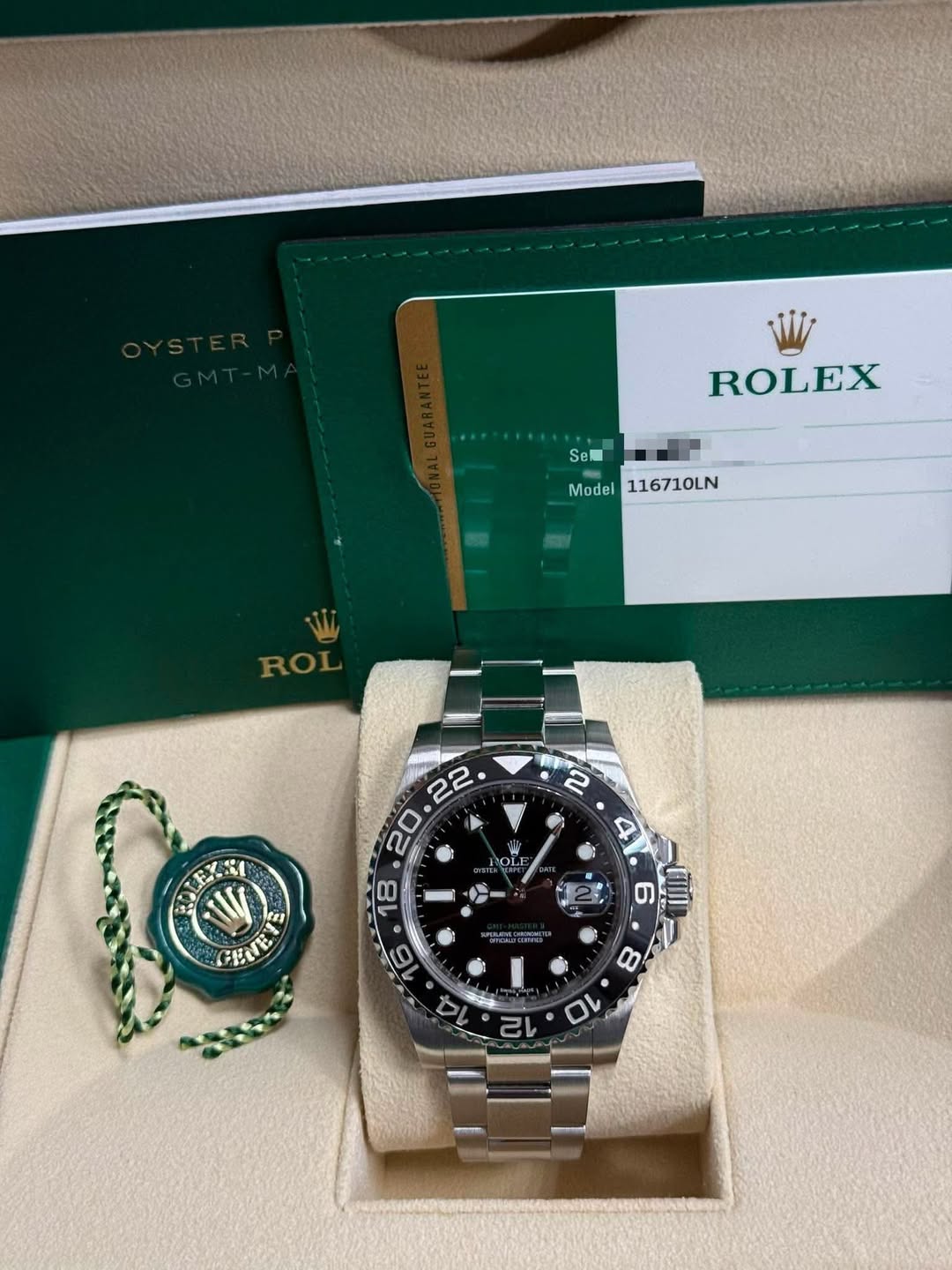 May be an image of wrist watch and text that says 'ROLEX Se Model116710LN Model 116710LN ROL HI GE GENTE 1D 8 2L'