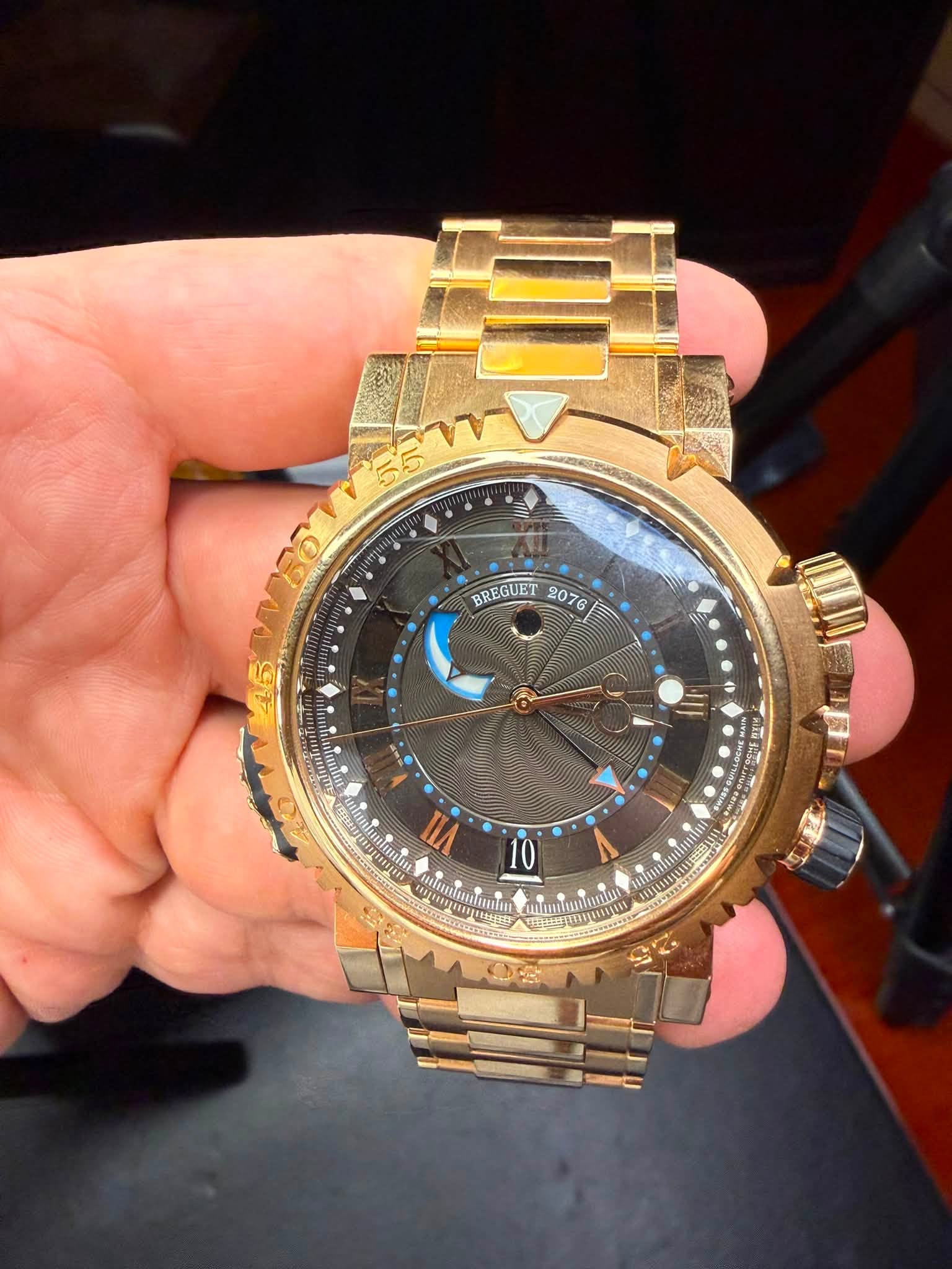 May be an image of wrist watch and text