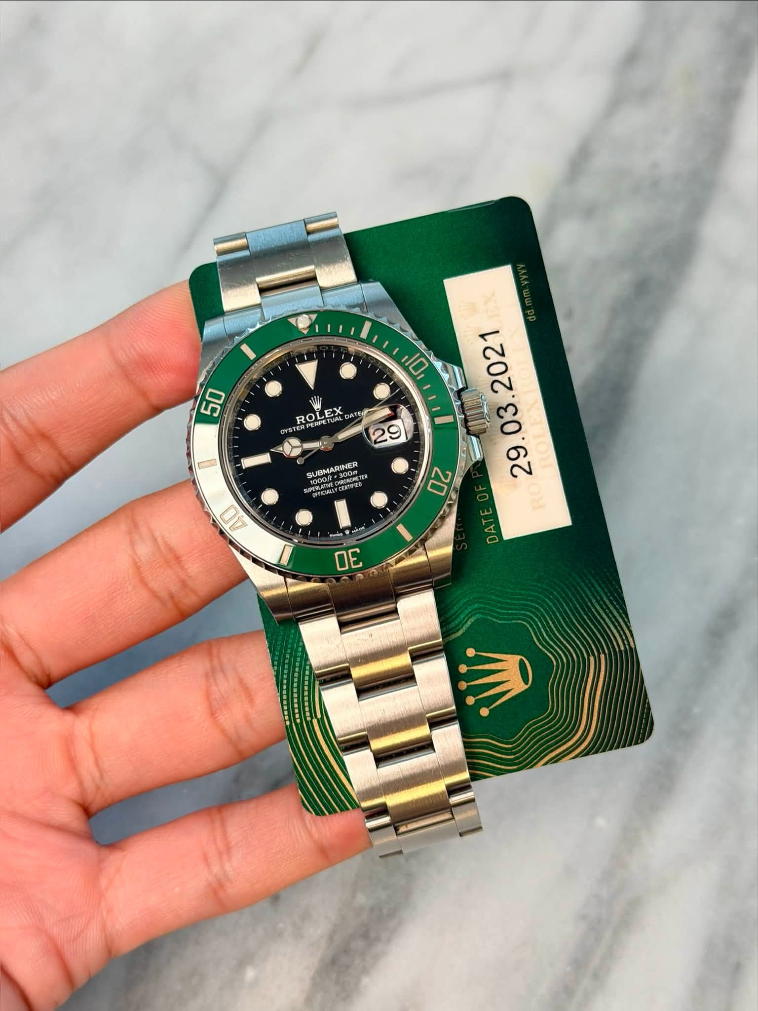 May be an image of wrist watch and text that says '50 TERPEN ល ROLEX ROL LEX S ROLE 0 29 SUBMARINER SA.300 CENTERS HX D . M DATE AO OE'