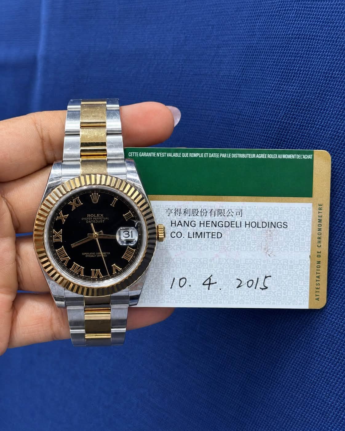 May be an image of wrist watch and text that says 'MECAEETETETATERERERERER TEGARANTIENESTYALABLE 3 享得利股份有限公司 HANG HENGDELI HANGHENGDELIHOLDINGS HOLDINGS co. LIMITED DE PA'