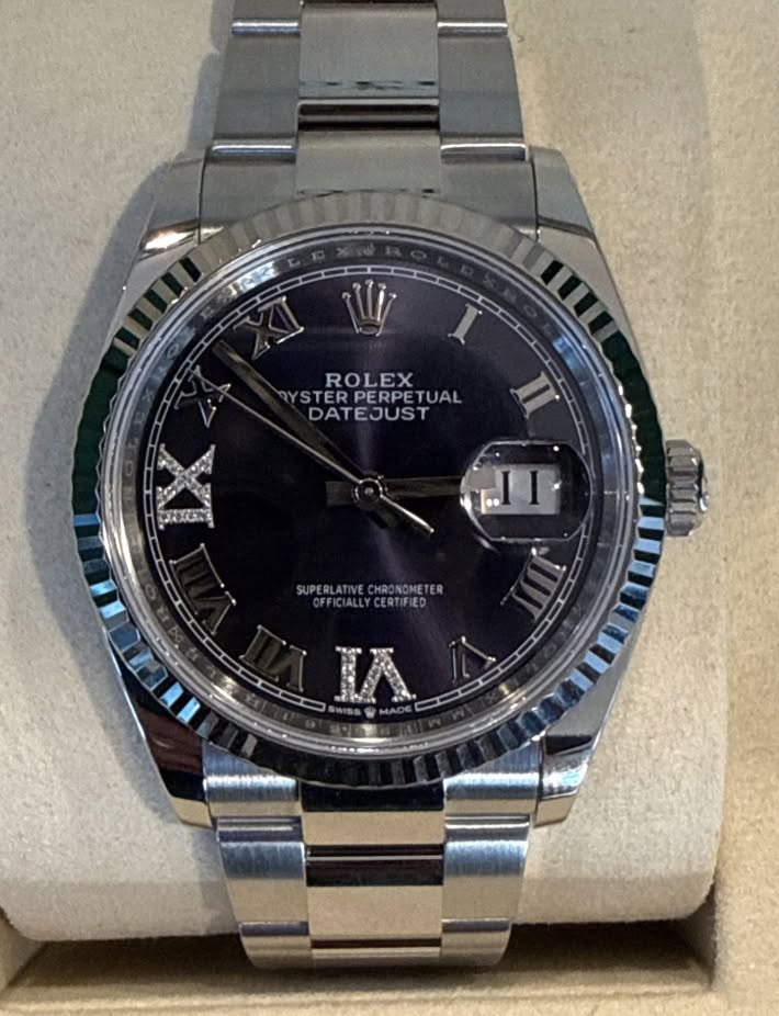 May be an image of wrist watch and text