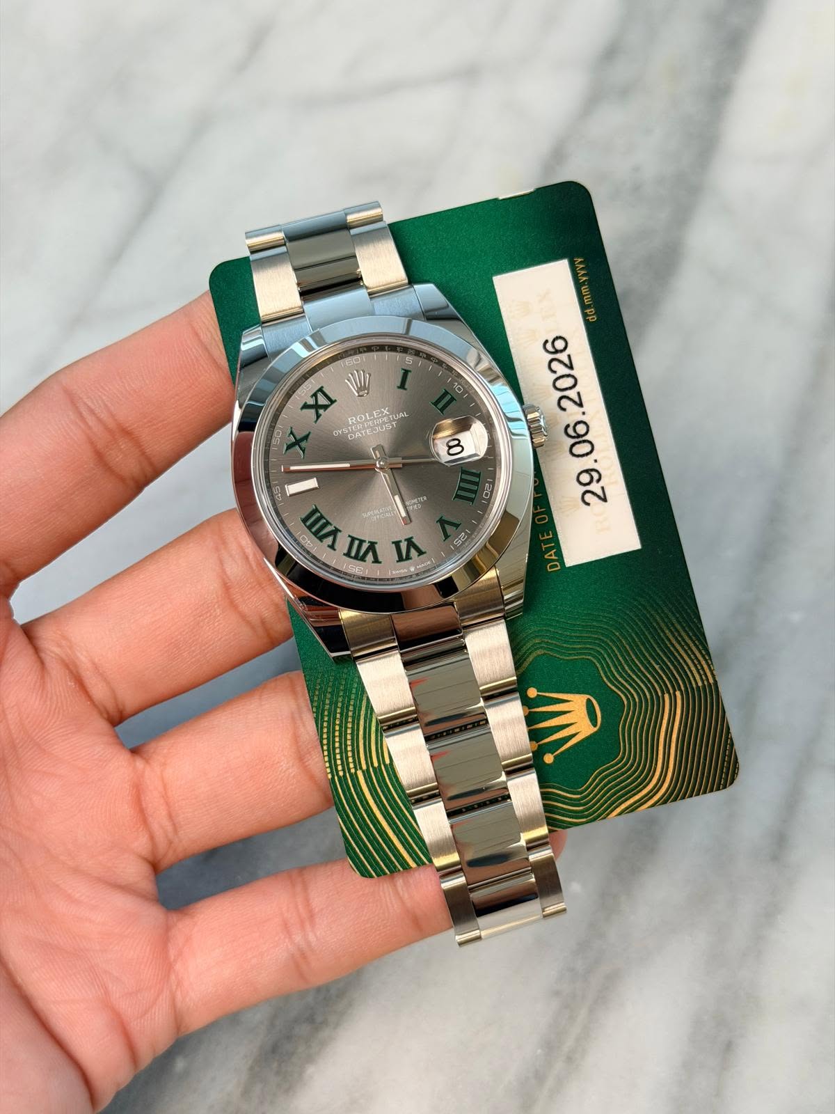 May be an image of wrist watch and text