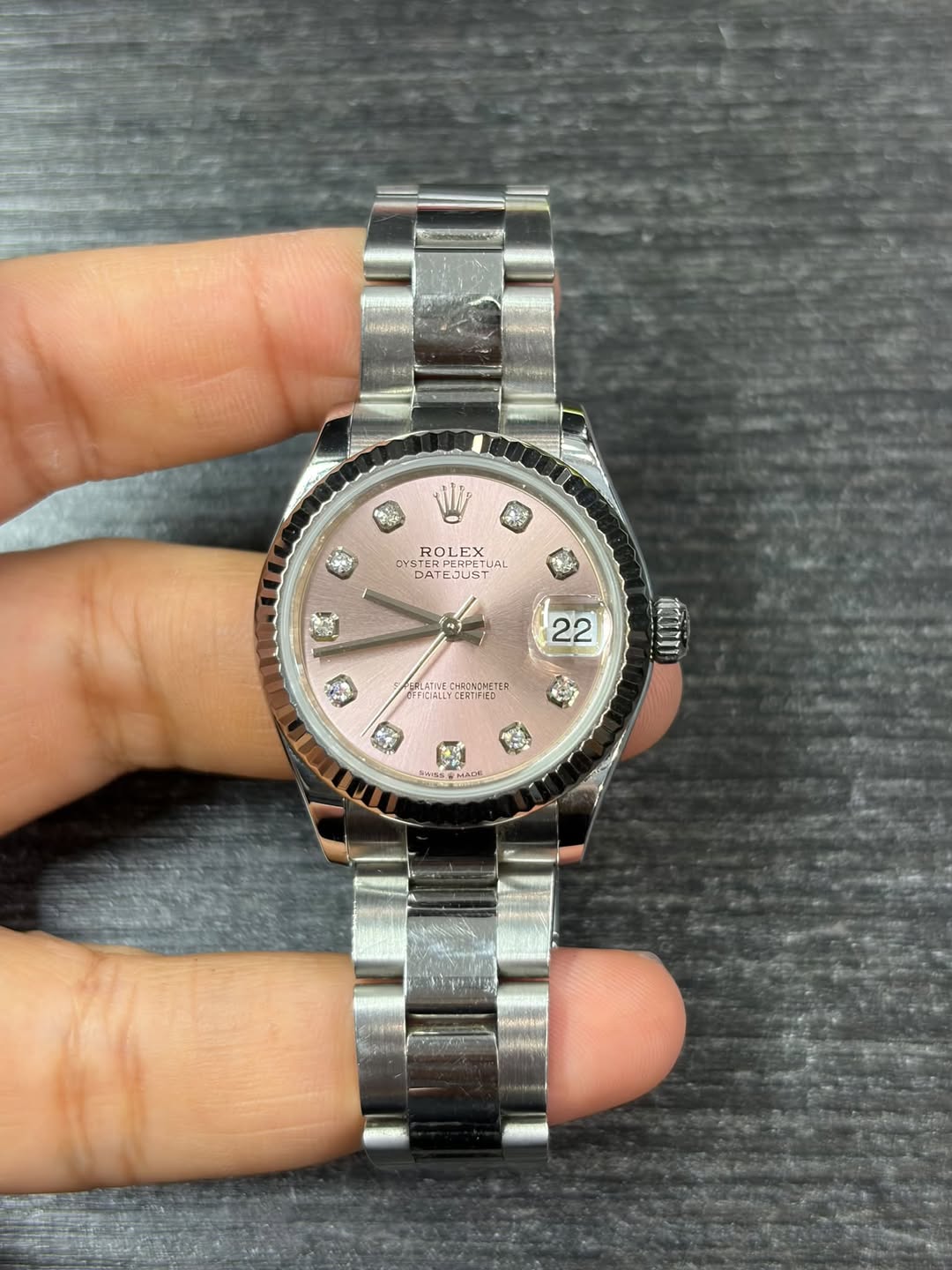 May be an image of wrist watch and text