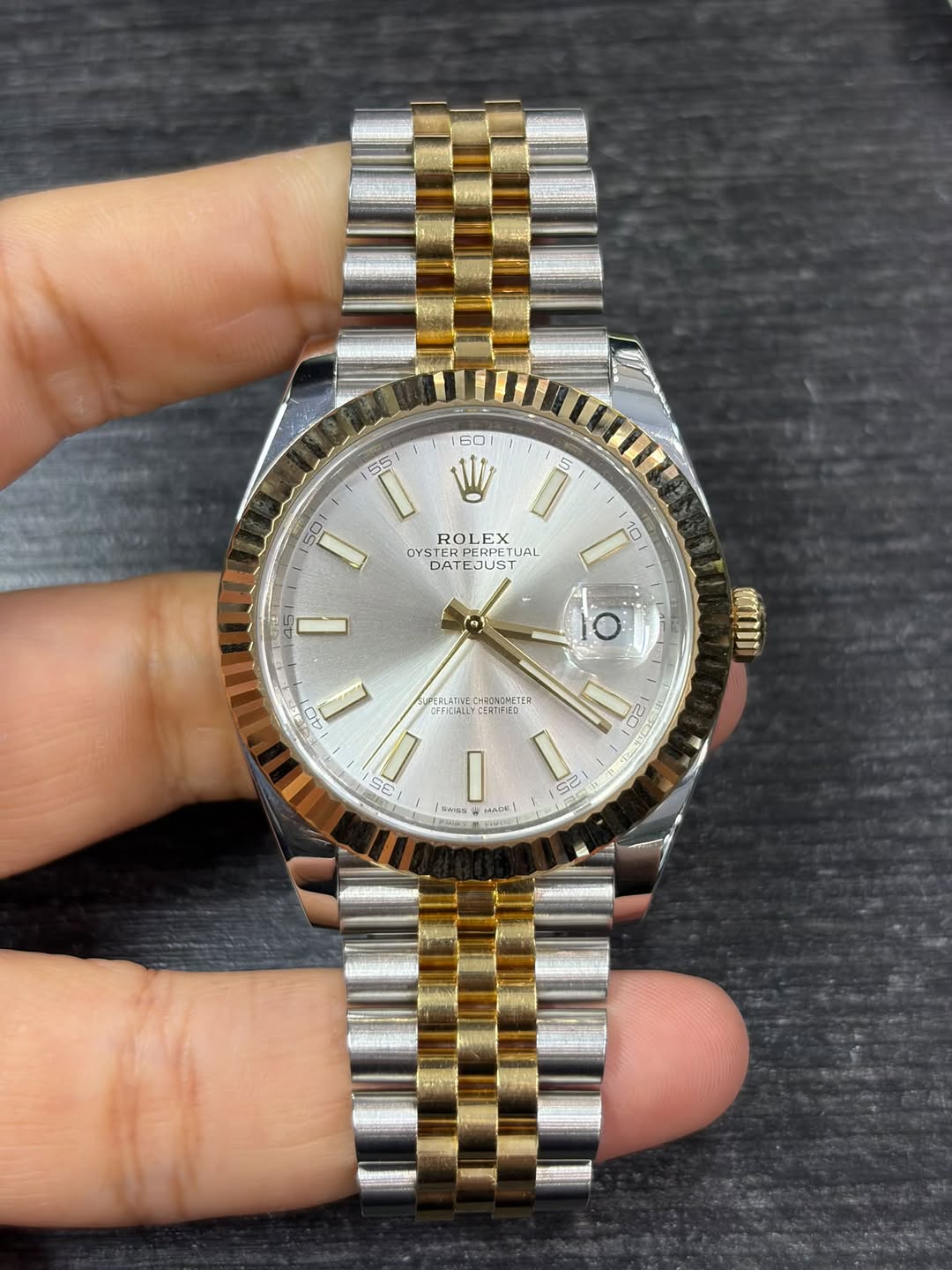 May be an image of wrist watch and text