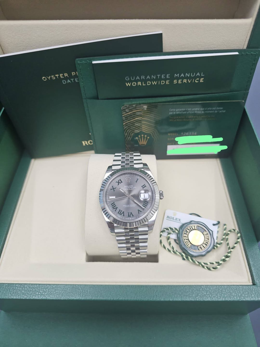 May be an image of wrist watch and text that says 'OYSDATE DATE OYSTERP PI GUARANT GUARANTEEMANUAL EE MANUAL WORLDWIDE WORLDWIDESERVICE SERVICE RO XI POT อ S 1 VIII トつ LE IA OND…
