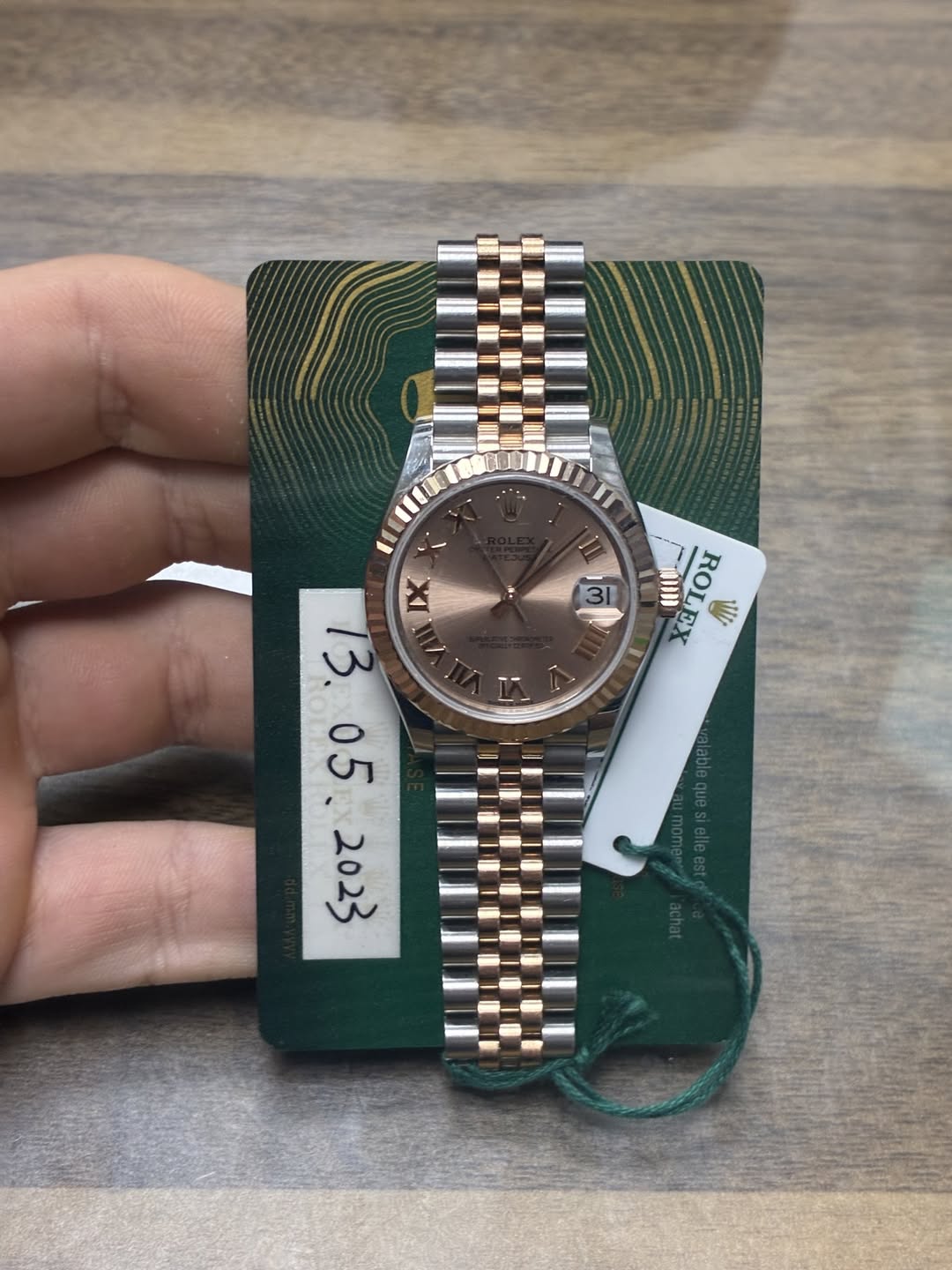 May be an image of wrist watch and text