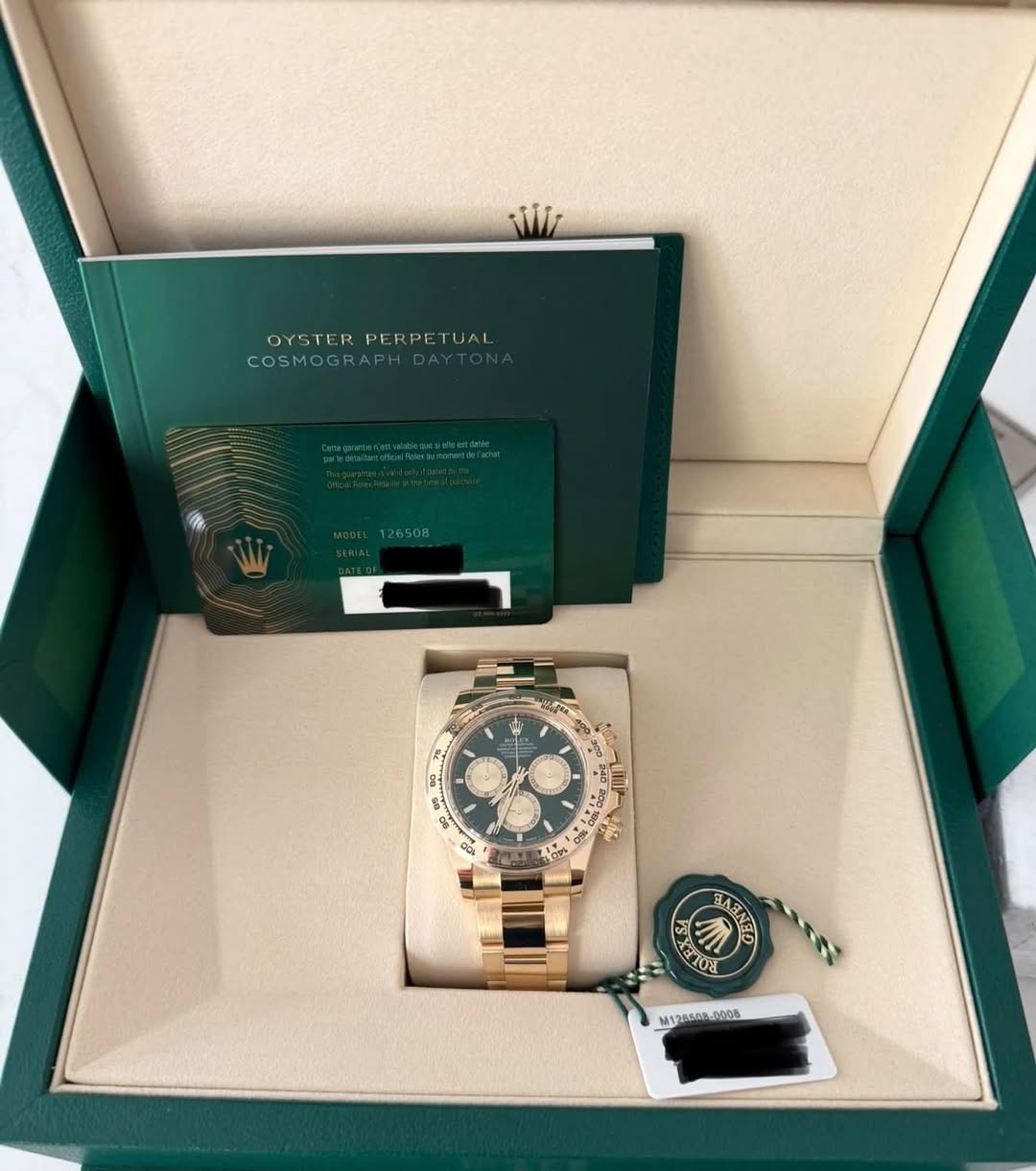 May be an image of wrist watch and text that says 'Wii OYSTERPERPETUAL OYSTER PERPETUAL COSMOGRAF DEL126508 HyK Hogr KII FO0 M12880P000B 12008 00A'