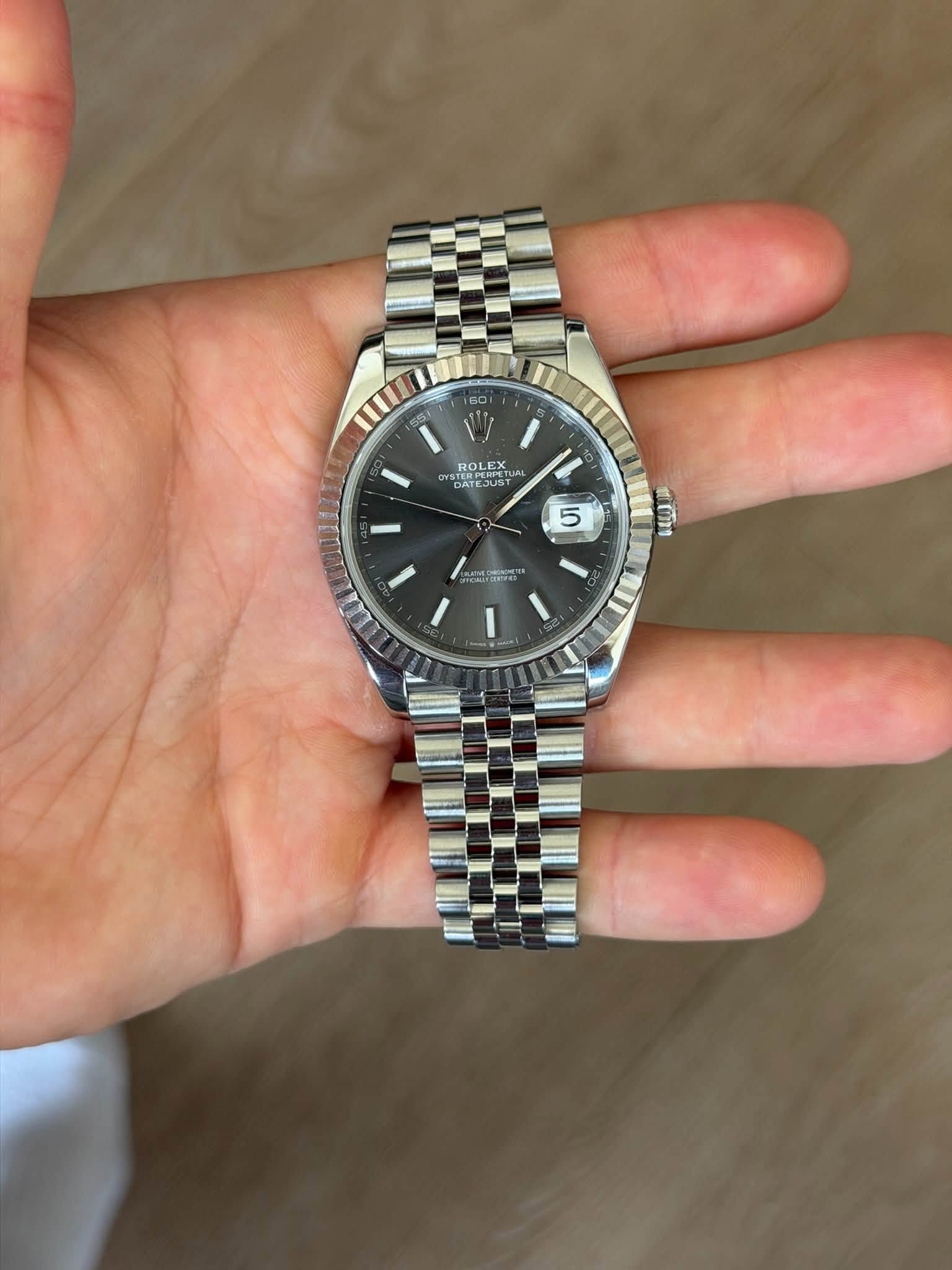 May be an image of wrist watch and text