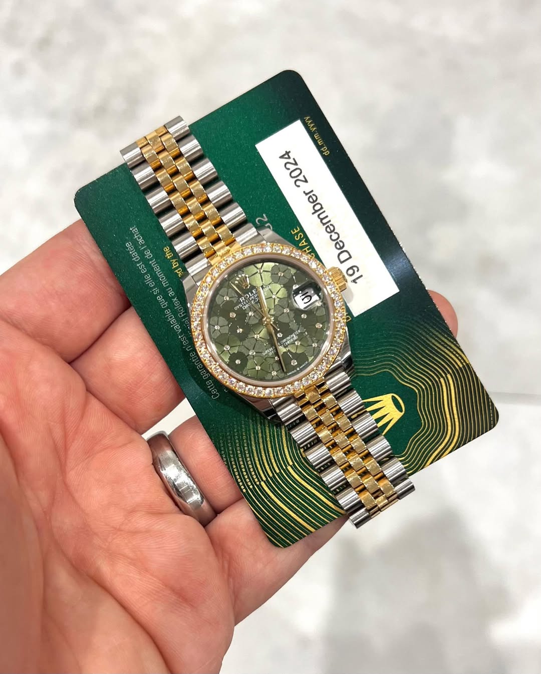 May be an image of wrist watch and text