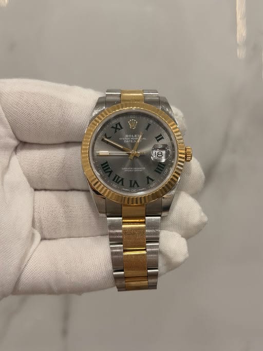 May be an image of wrist watch and text