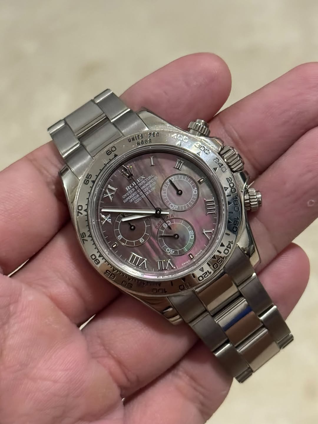 May be an image of wrist watch and text