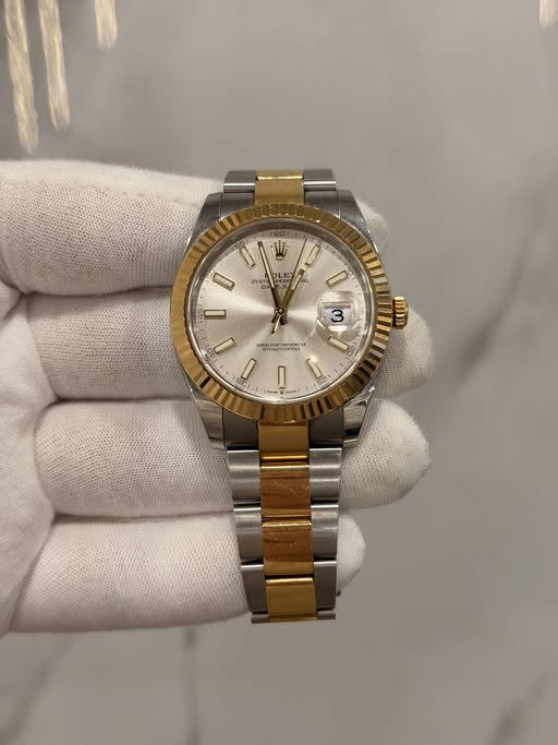May be an image of wrist watch and text