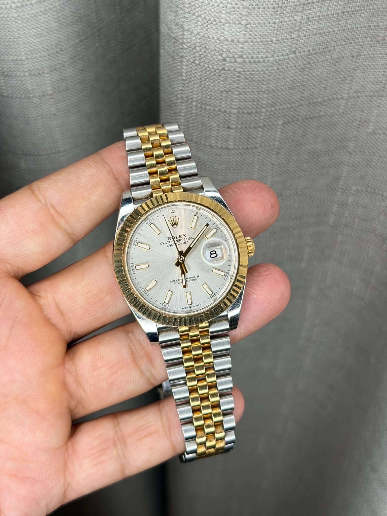 May be an image of wrist watch and text