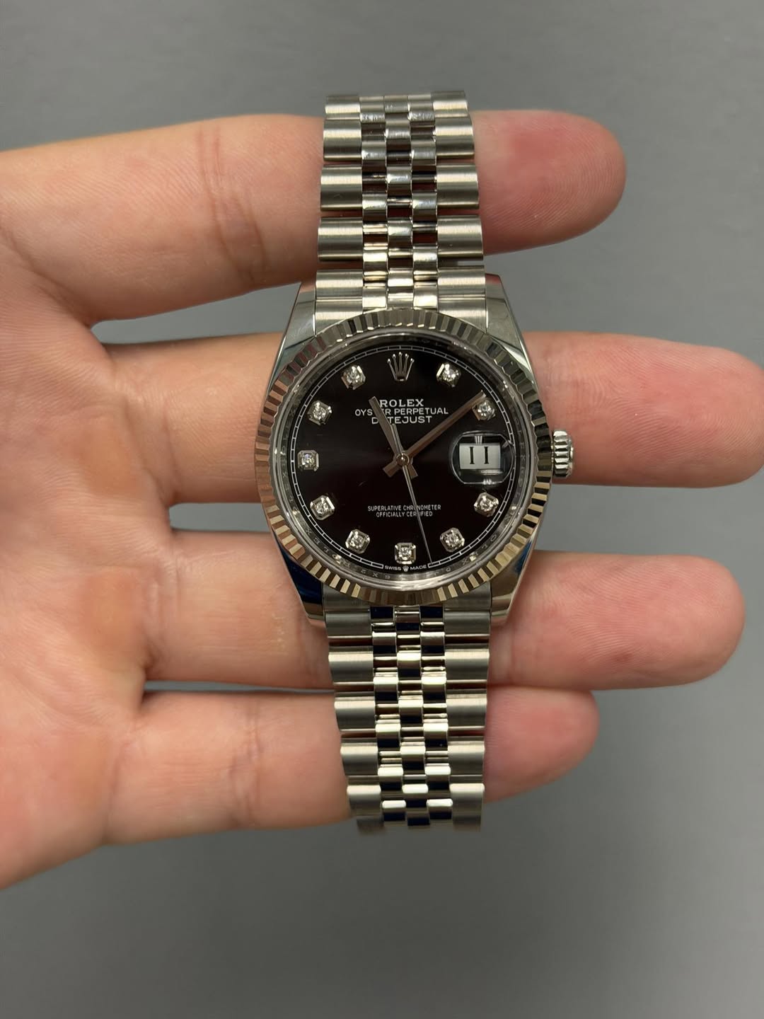 May be an image of wrist watch and text