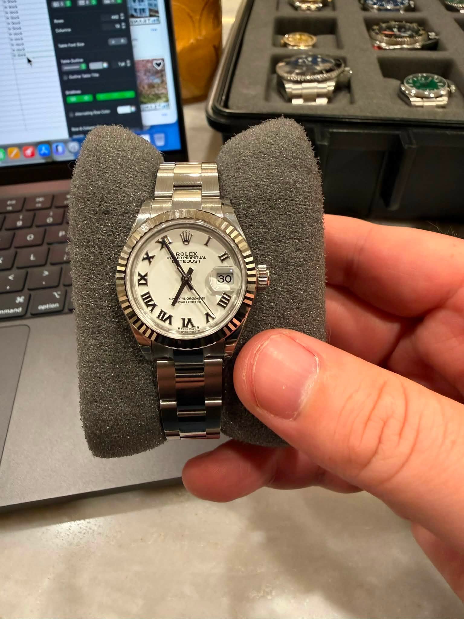 May be an image of wrist watch and text