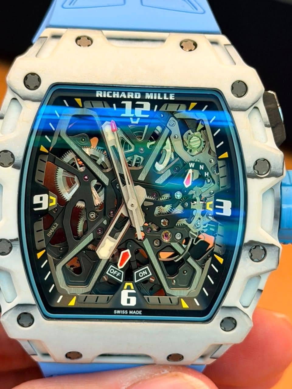 May be an image of wrist watch and text that says 'RICHARD MILLE 12 دو MLS O س RMAL2 3 OFF ON G SWISS MADE'