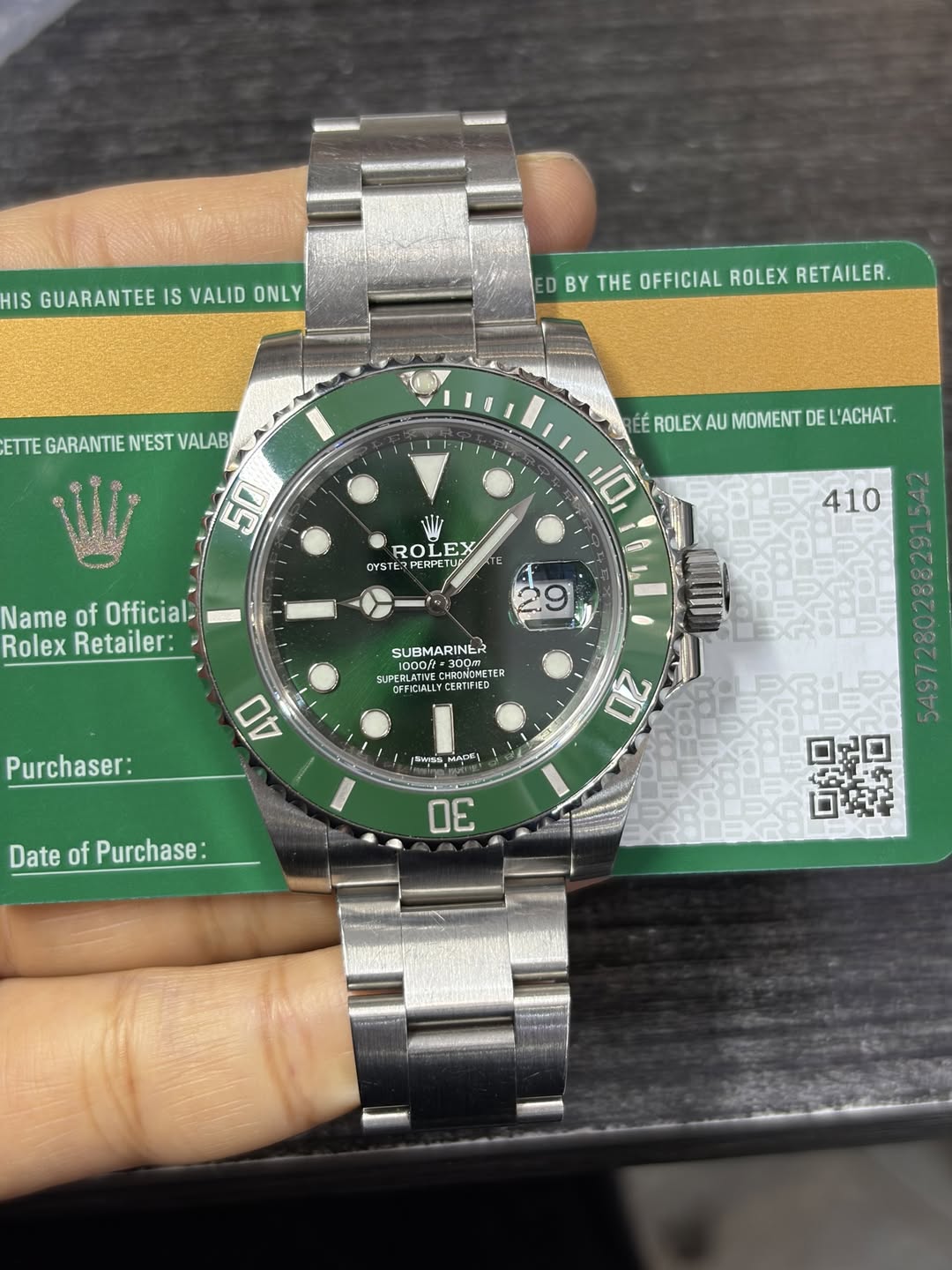 May be an image of wrist watch and text that says 'HIS GUARANTEE IS VALID ONLY D DBYTHEOFFICIALROLEXRETAILER BY THE OFFICIAL ROLEX RETAILER. ETTE GARANTIE N'EST VALAB 50 ÉÉ…