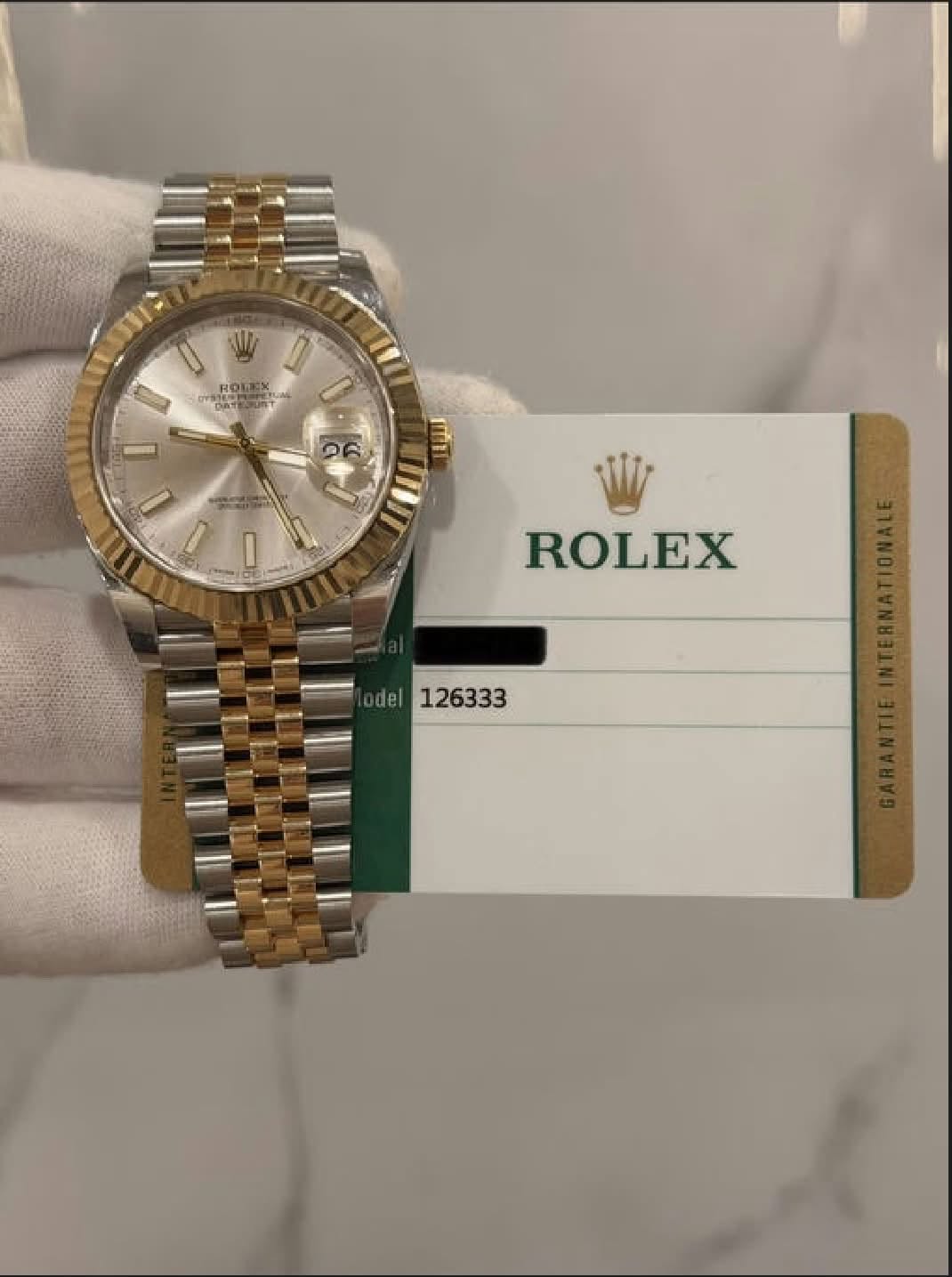 May be an image of wrist watch and text that says 'ROLEX ロ 04 ១ U ROLEX del 126333'