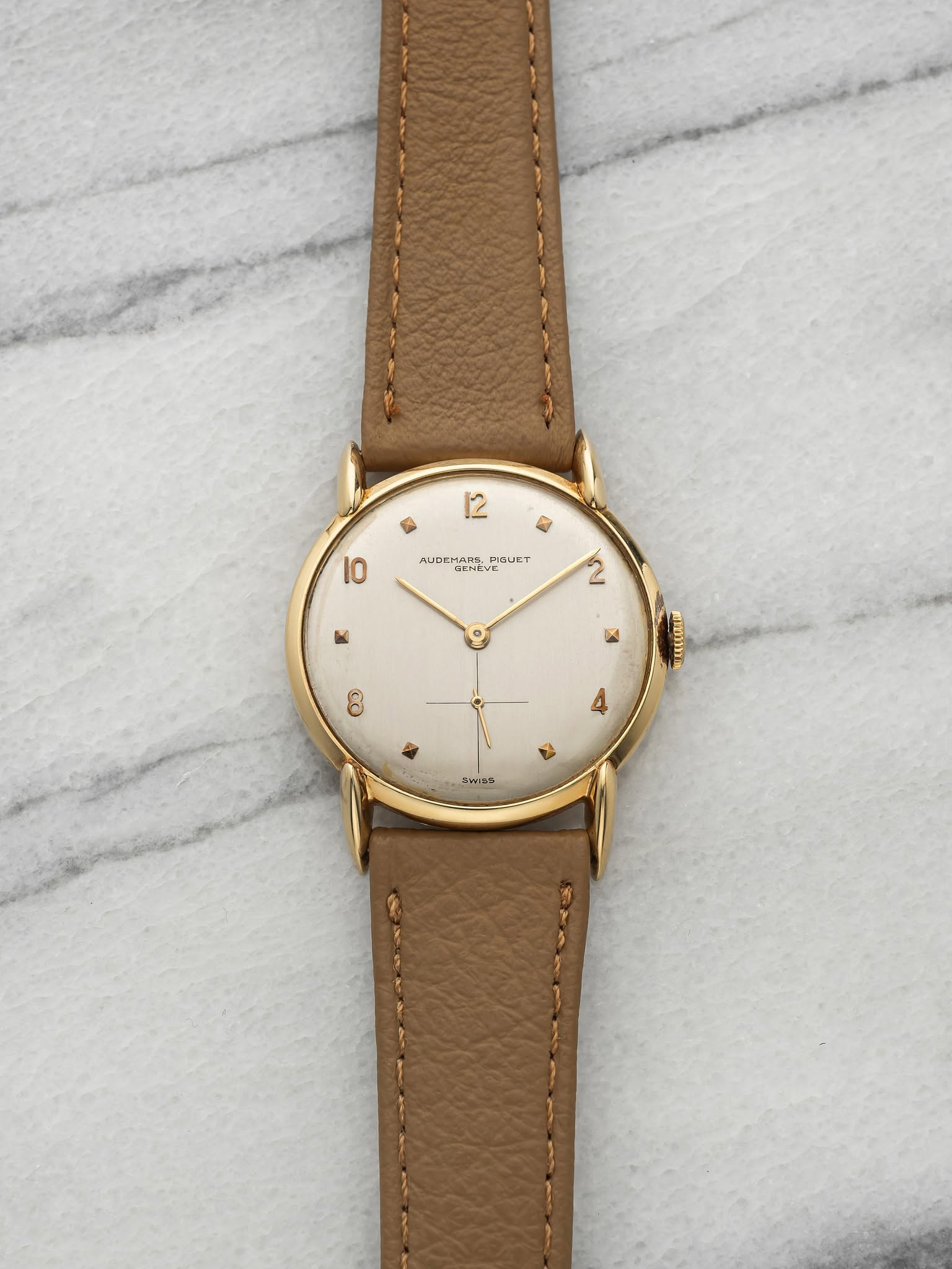 May be an image of leather, wrist watch and text
