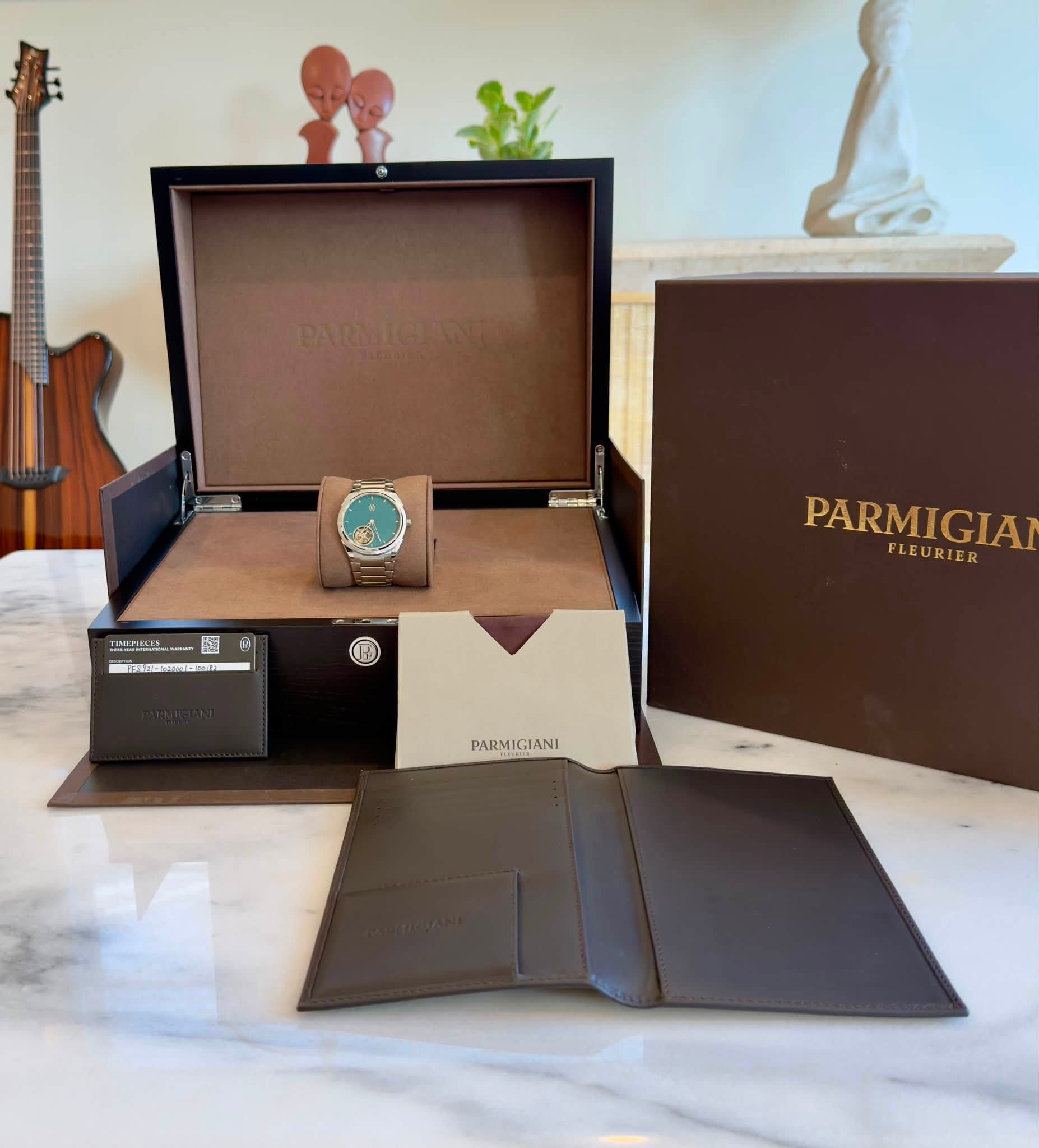 May be an image of wrist watch, saddle-stitched leather, leather, cufflinks, leather wallet and text