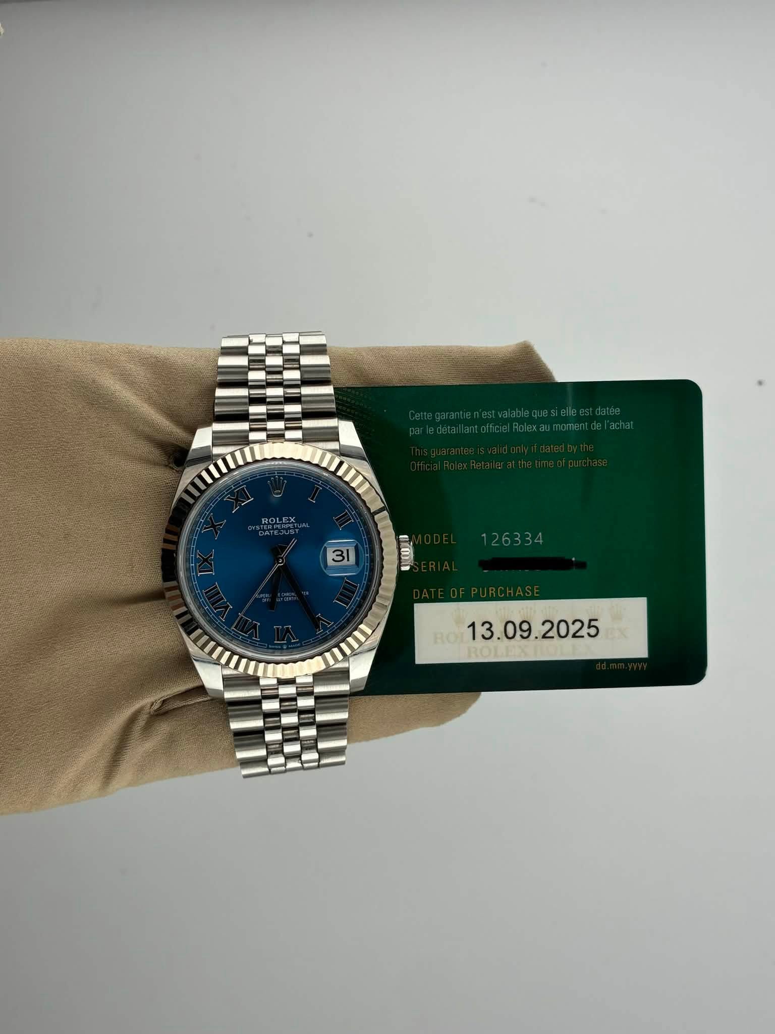 May be an image of wrist watch and text that says 'ROLEX 31 E J ROT R13. RO'
