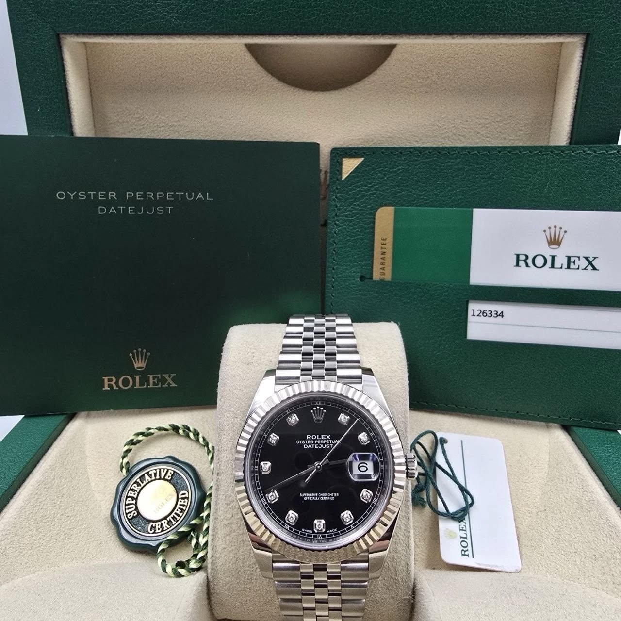 May be an image of wrist watch and text that says 'OYST OYSTERPERPETUAL PERPETUAL TUAL DATEJUST DATE UARANTEE ROLEX 126334 ROLE 沙 ቤ S ROLEX OLEX DATEAS GAIERT 8 6 ュ മக" ក្កុចា CE আ…