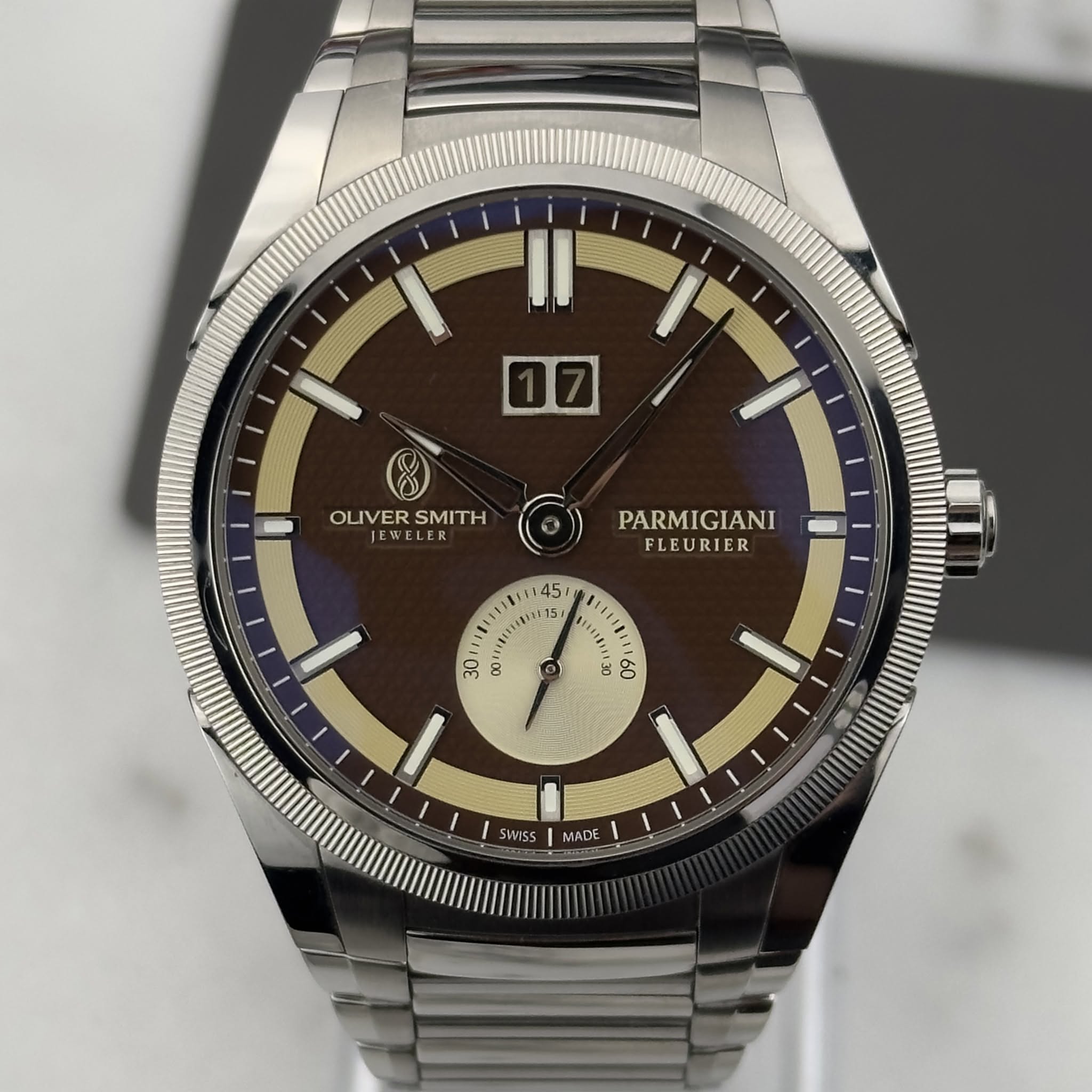May be an image of wrist watch and text that says 'OLIVERSMITH W EWELER LER OLIVER SMITH PARMIGIANI FLEURIER S0 50 SWSS MADE'