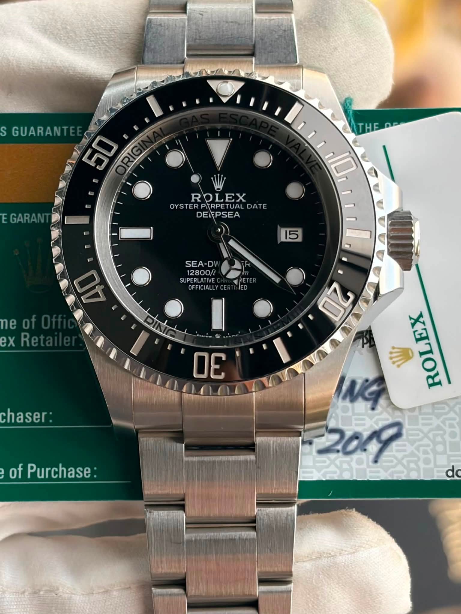 May be an image of wrist watch and text that says 'S GUARANT o 50 HE GARAN ROLEX OYSTERPIRPETUAL OY OYSTE PIRPETUAL DATE DEEPSEA 10 1 15 SEA-DV 12800/ 12800/ UPERLATIV ERLATIVE…