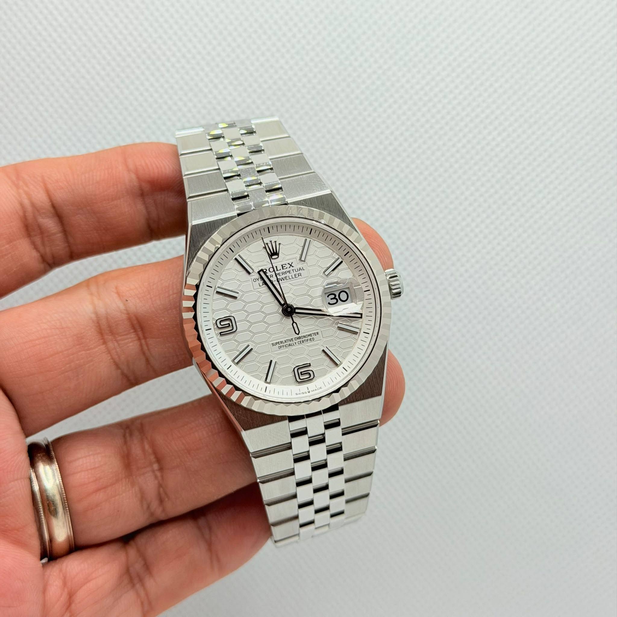 May be an image of wrist watch and text