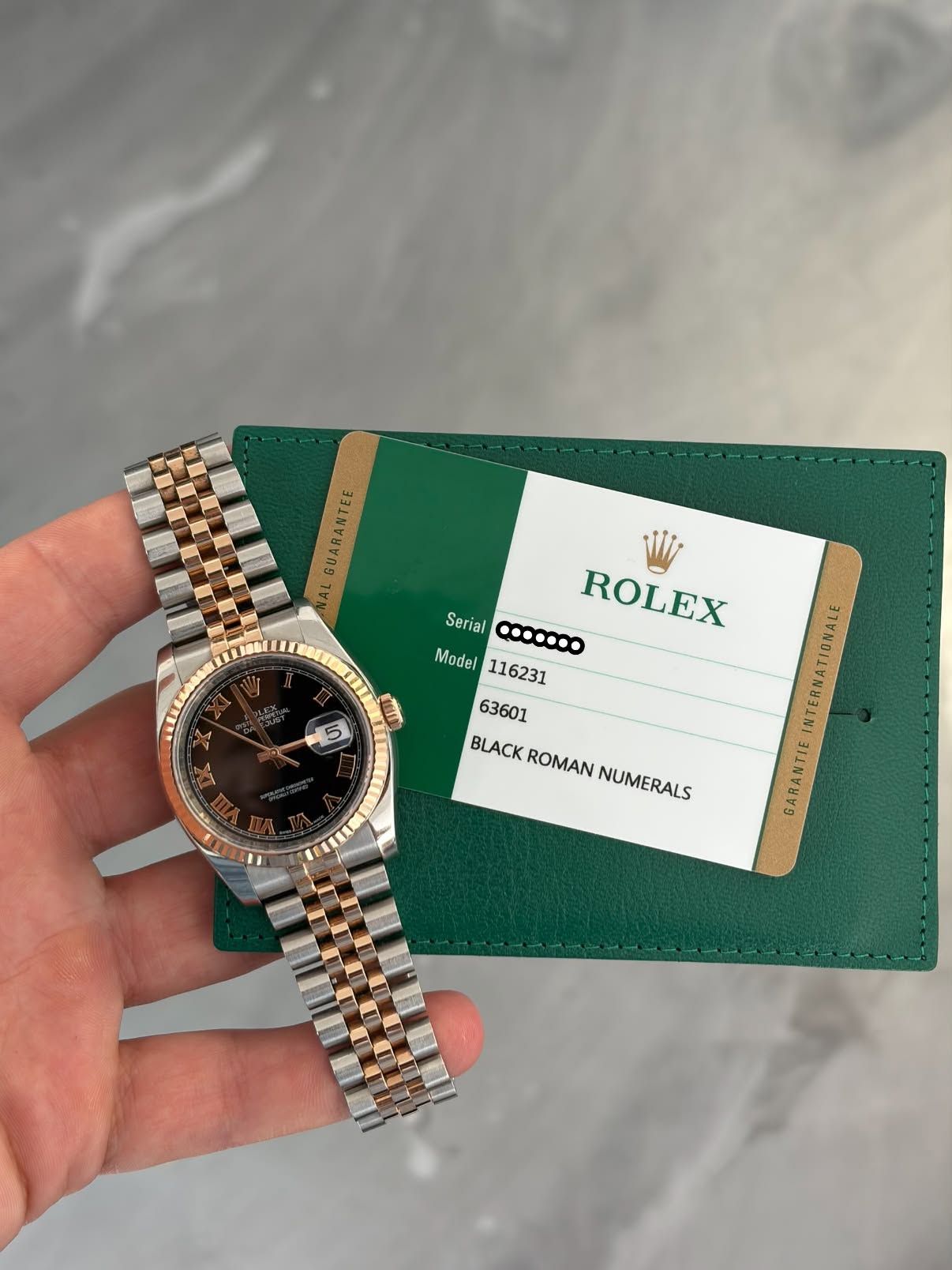 May be an image of wrist watch and text that says 'GUARANTEE AL GUARANTEE UI 5 Serial ...... ROLEX Model Model116231 BLACKROMAN BLACK ROMAN NUMERALS INTERNATIONALE GARANTIE'