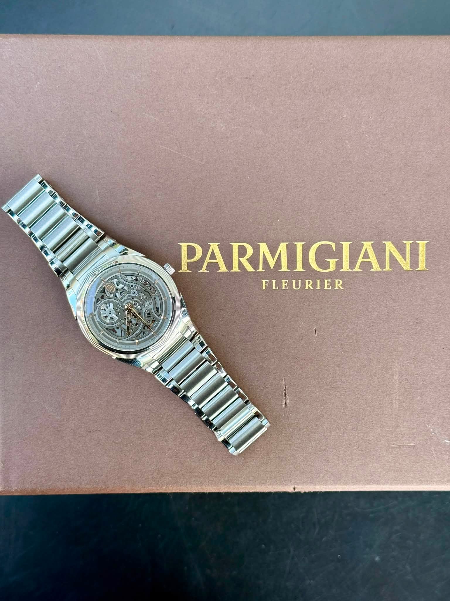 May be an image of wrist watch and text that says '. α RAN PARMIGIANI FLEURIER'