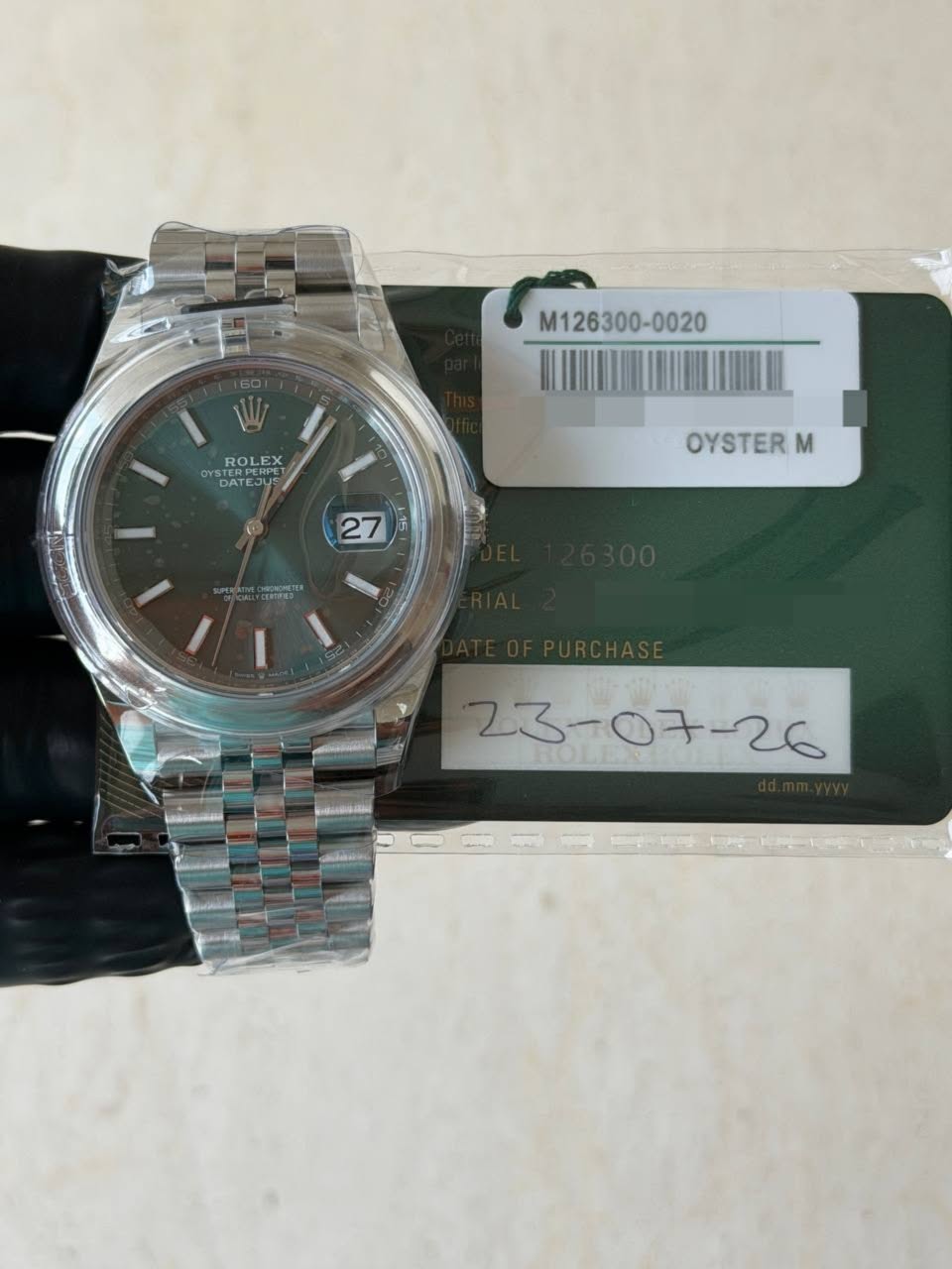 May be an image of wrist watch and text that says 'M126300-0020 ROLE EX X OYs ERPE RPC DATEJU DATEJUS OE AT OYSTER M 27 समततহ 23-07-26'