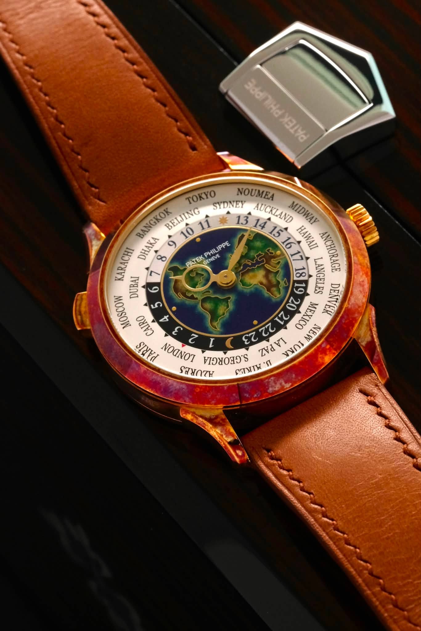 May be an image of wrist watch, map and text