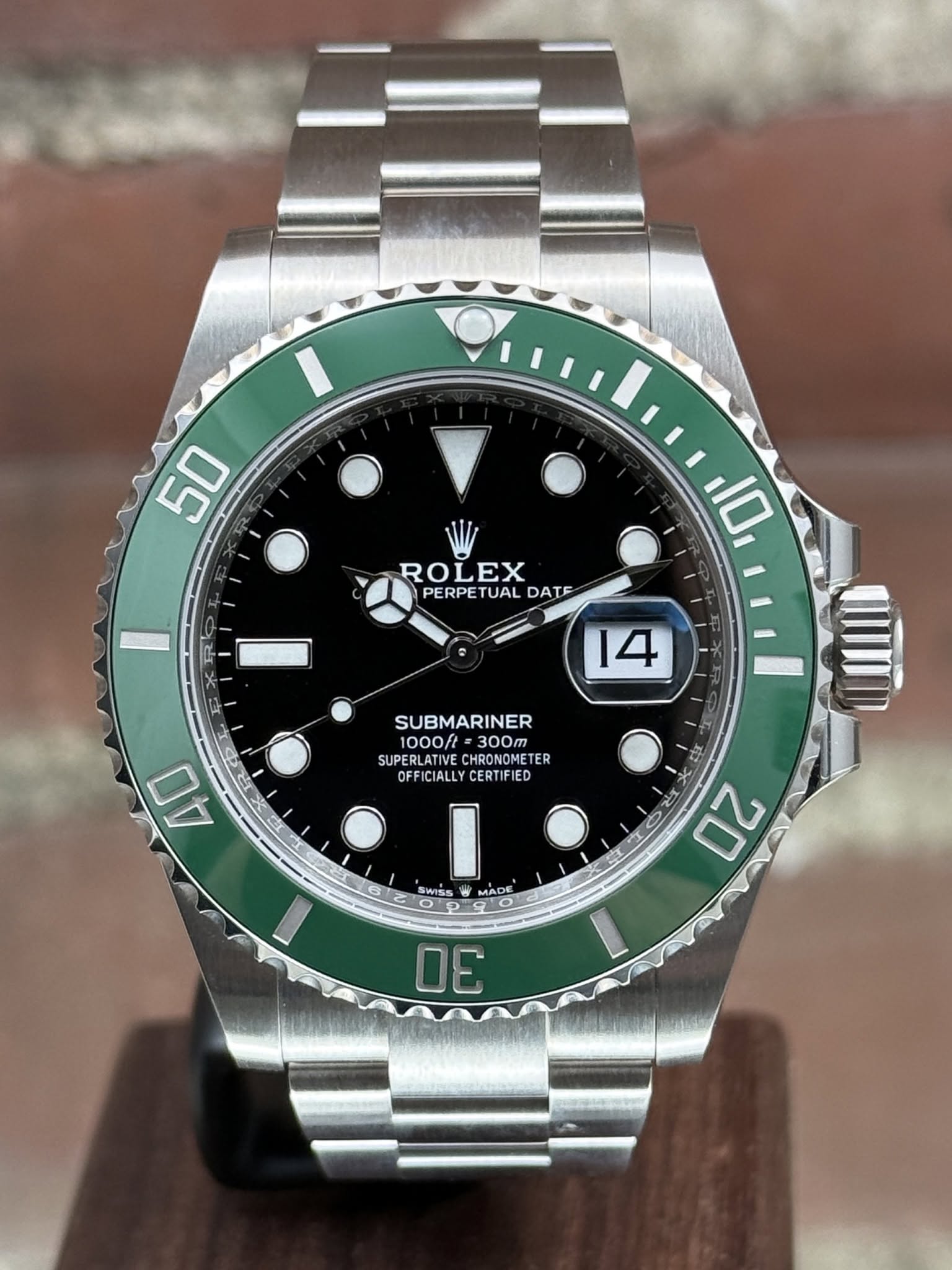 May be an image of wrist watch and text that says '50 ROLEX PERPETUAL PERPET TUAL DATE 10 14 SUBMARINER 1000f 300m SUPERLATIVE CHRONOMETE ER OFFICIALLYCERTIFIED OFF OFFICIALLY…