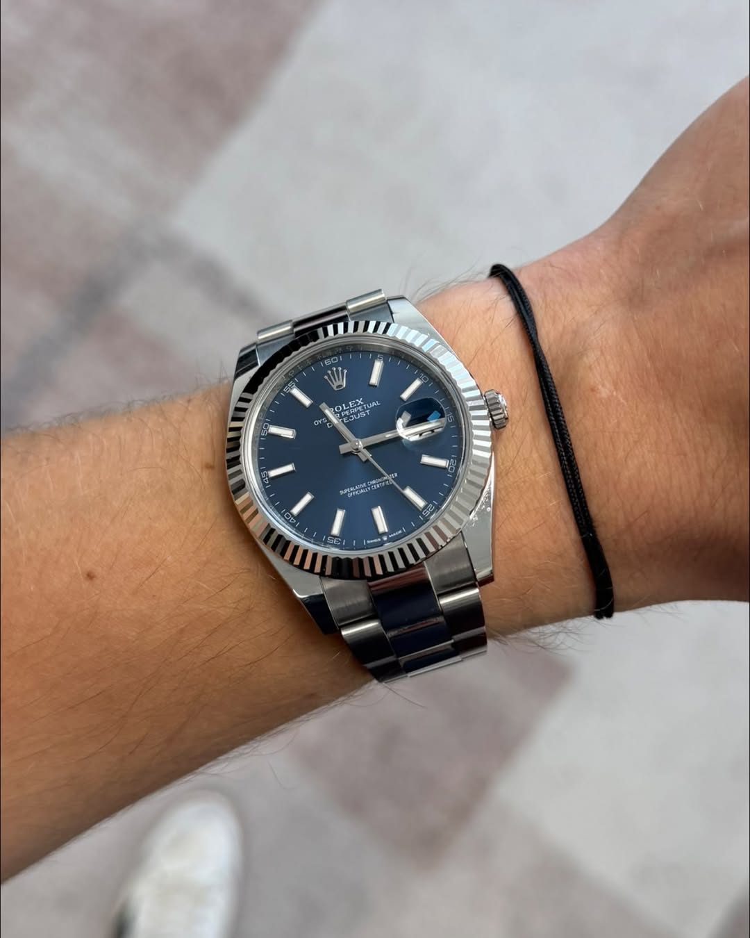 May be an image of wrist watch and text