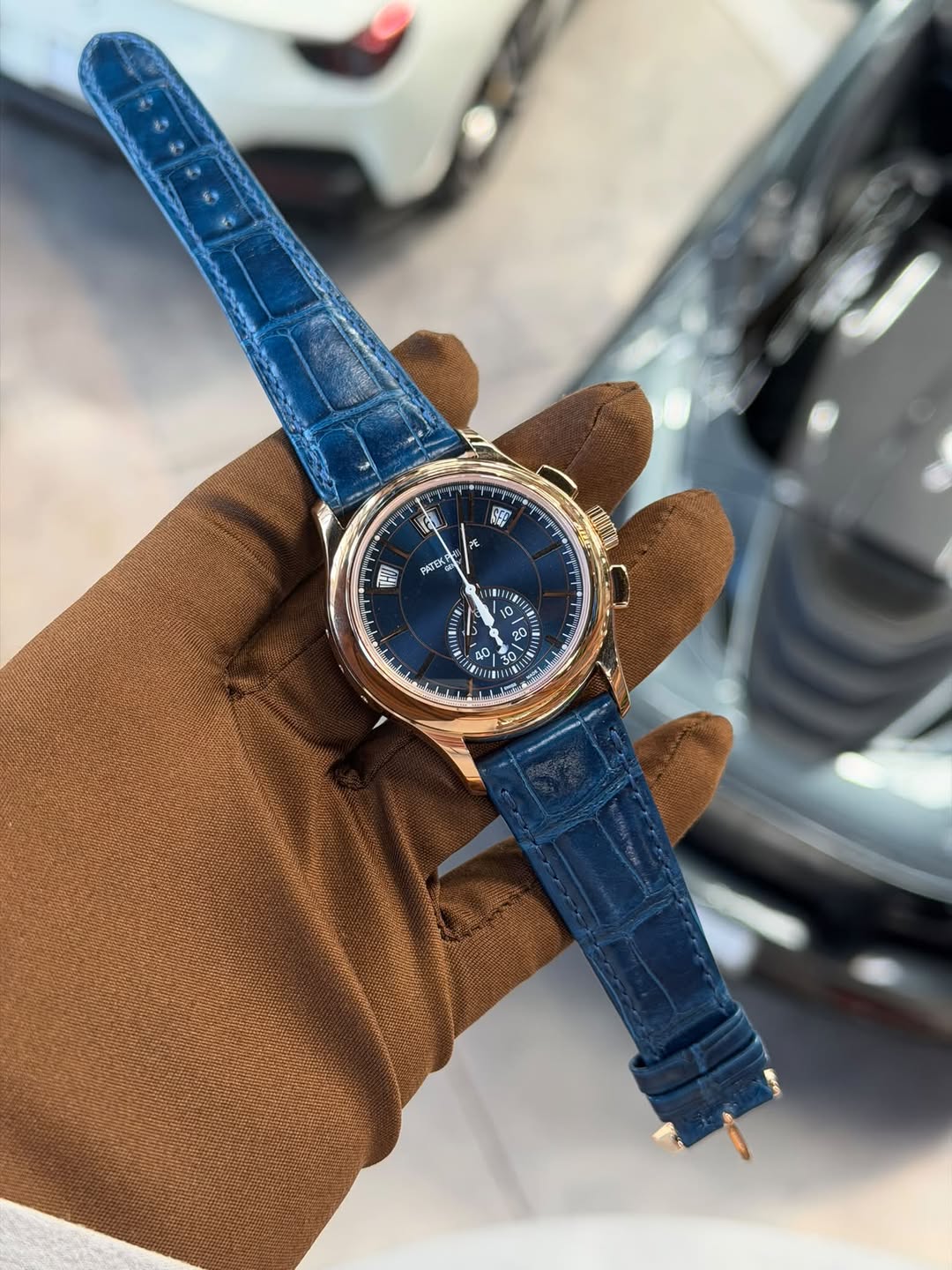 May be an image of wrist watch, leather and text