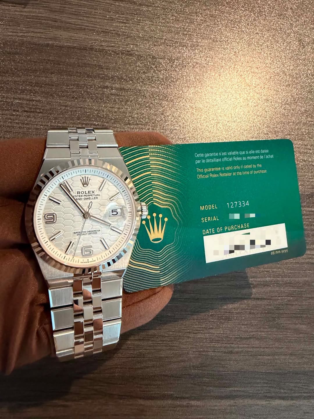 May be an image of wrist watch, ticket stub and text