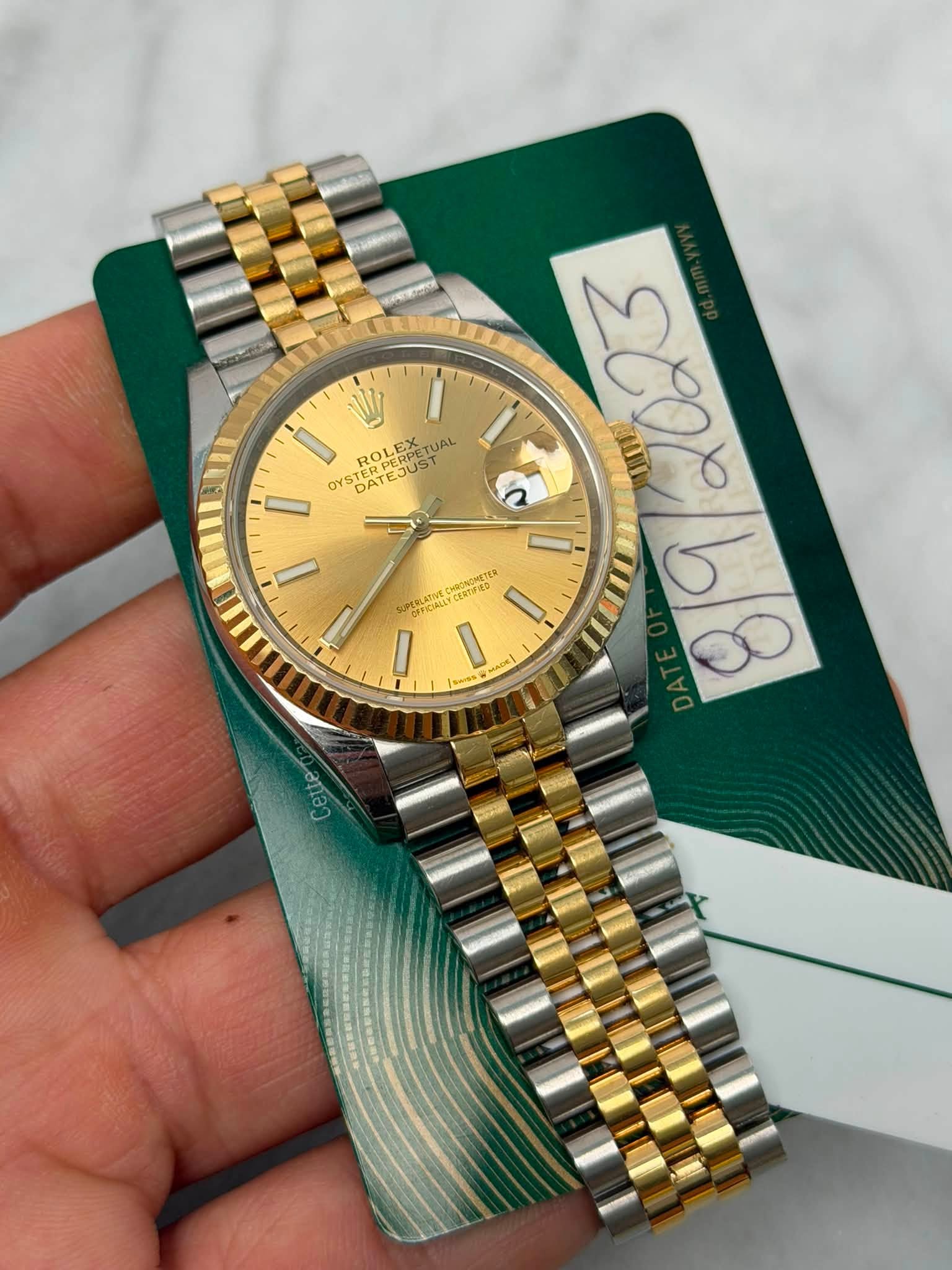 May be an image of wrist watch and text