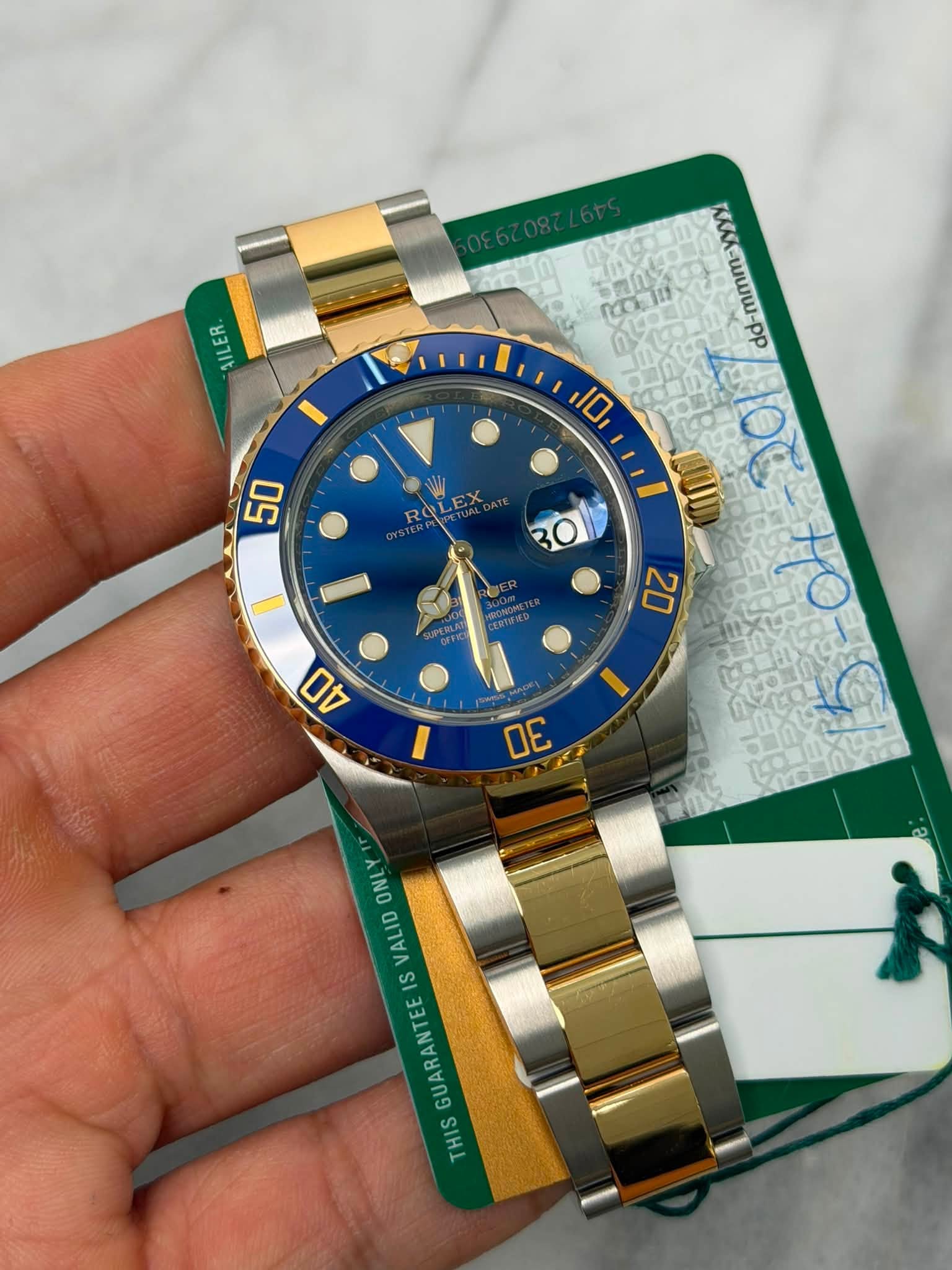 May be an image of wrist watch and text that says 'AILER IL ER サンム ひだは d-mmm- dd-mmm-yyy dd 10ه 10 50 ROLEX B0 20 40 DE ONL VALID IS GUARANTEE THIS ز'