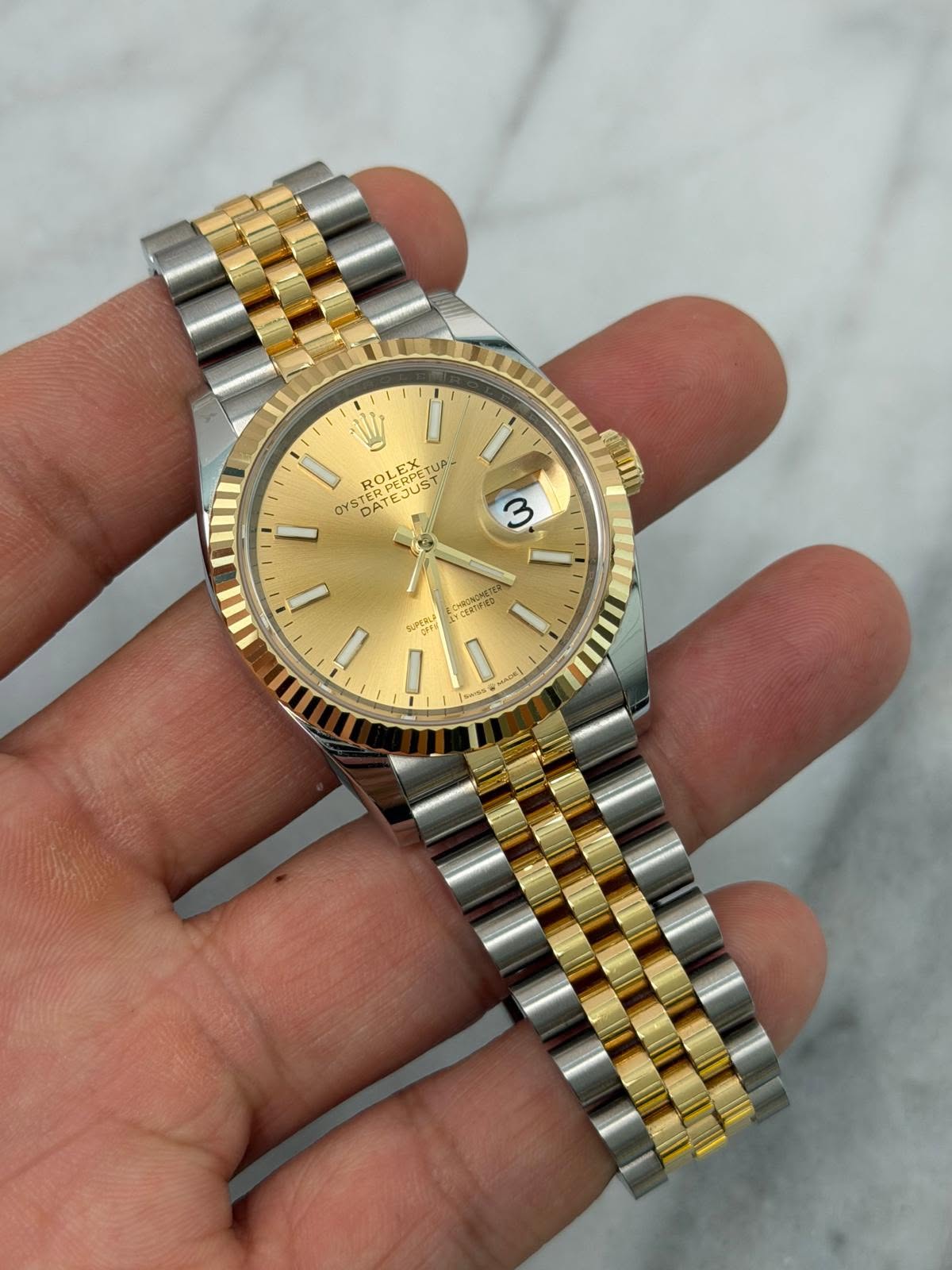 May be an image of wrist watch and text