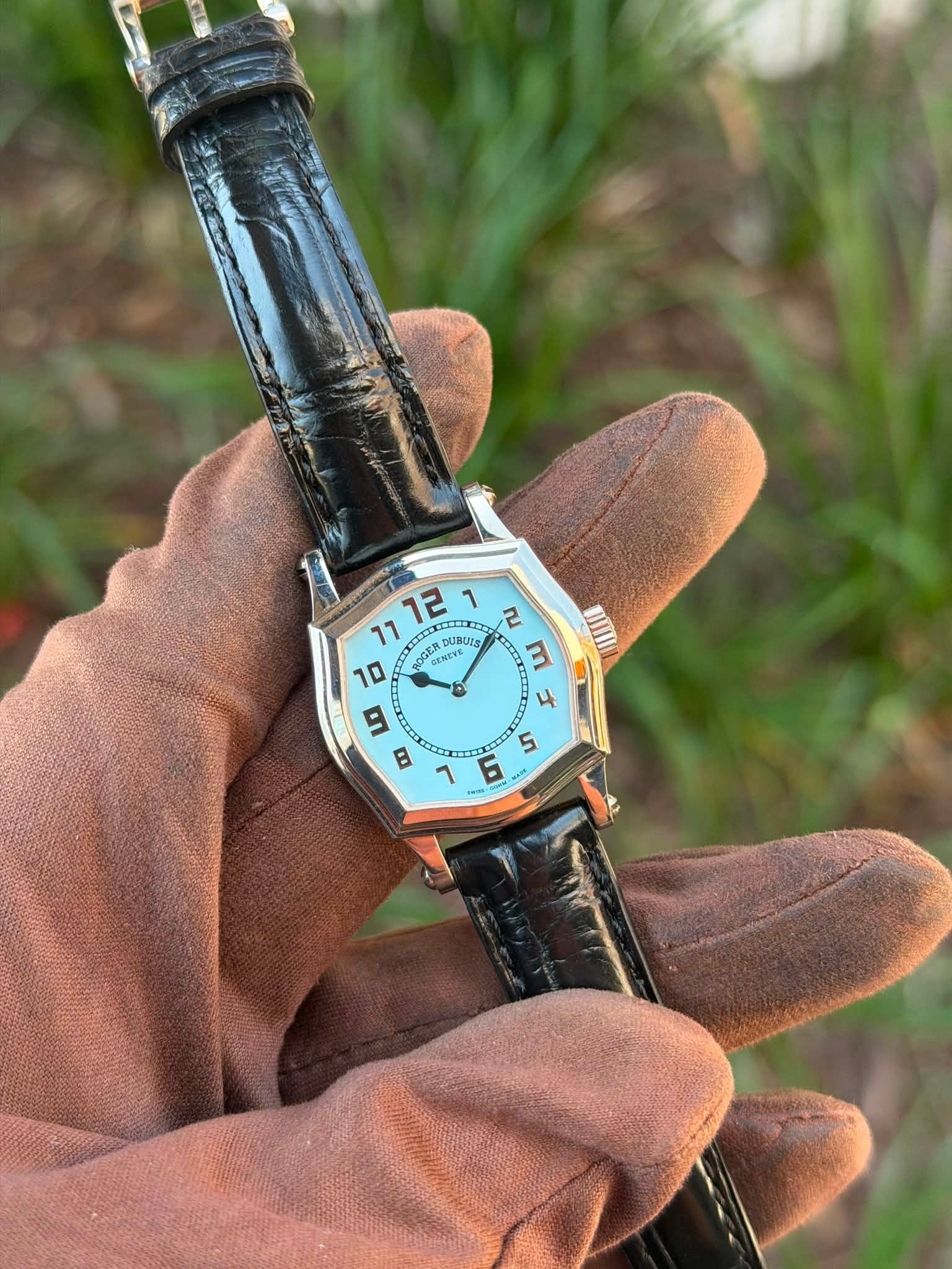 May be an image of digital watch, leather and text