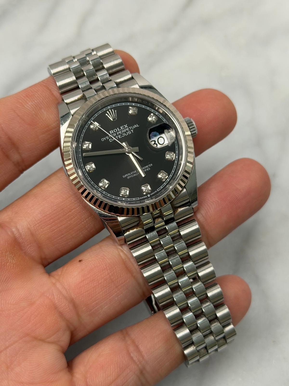 May be an image of wrist watch and text