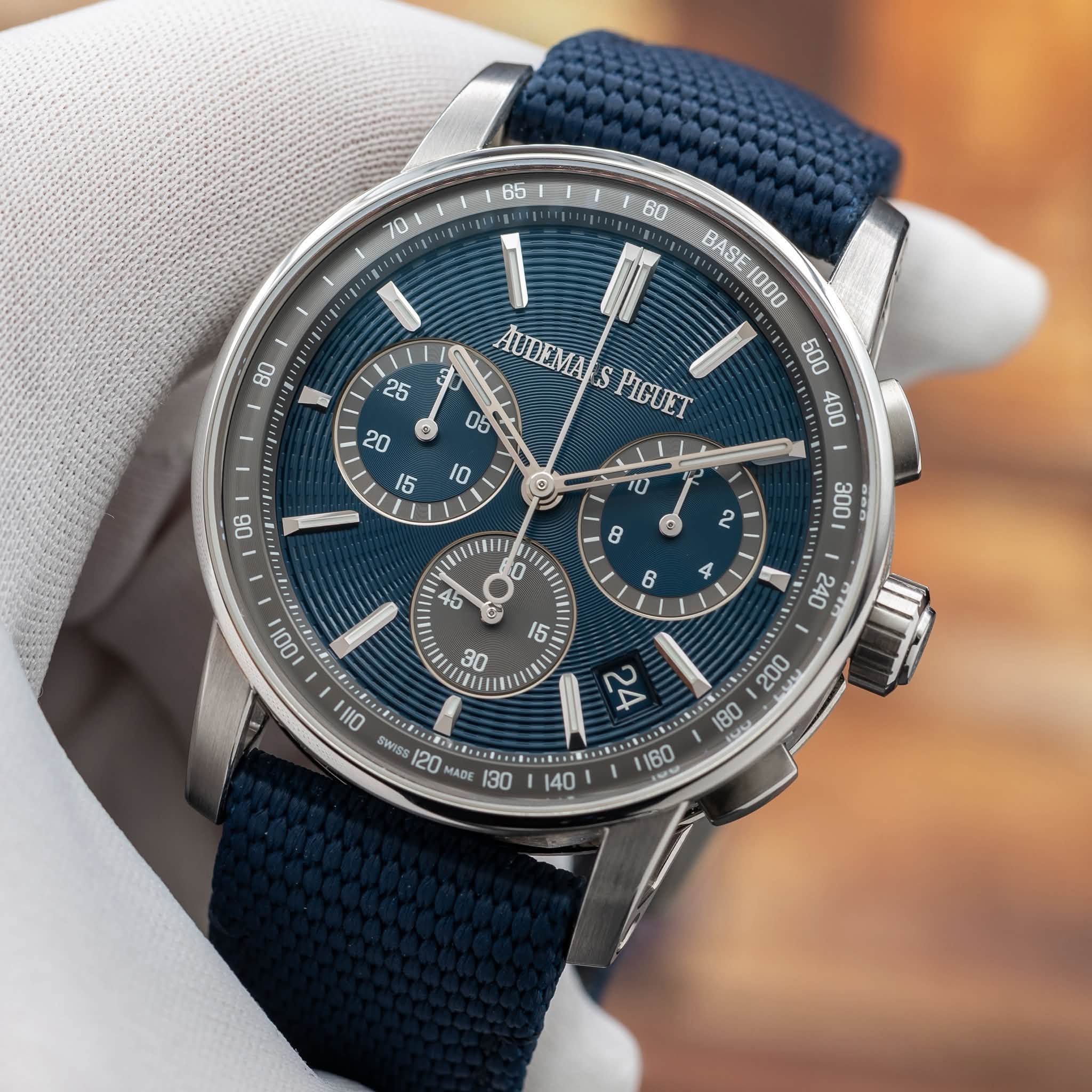 May be an image of wrist watch and text that says ' EsATgR BASE1000 1000 BASE AUDEMA S PIGUET C A 240 111O SWISS 120 MADE TO '