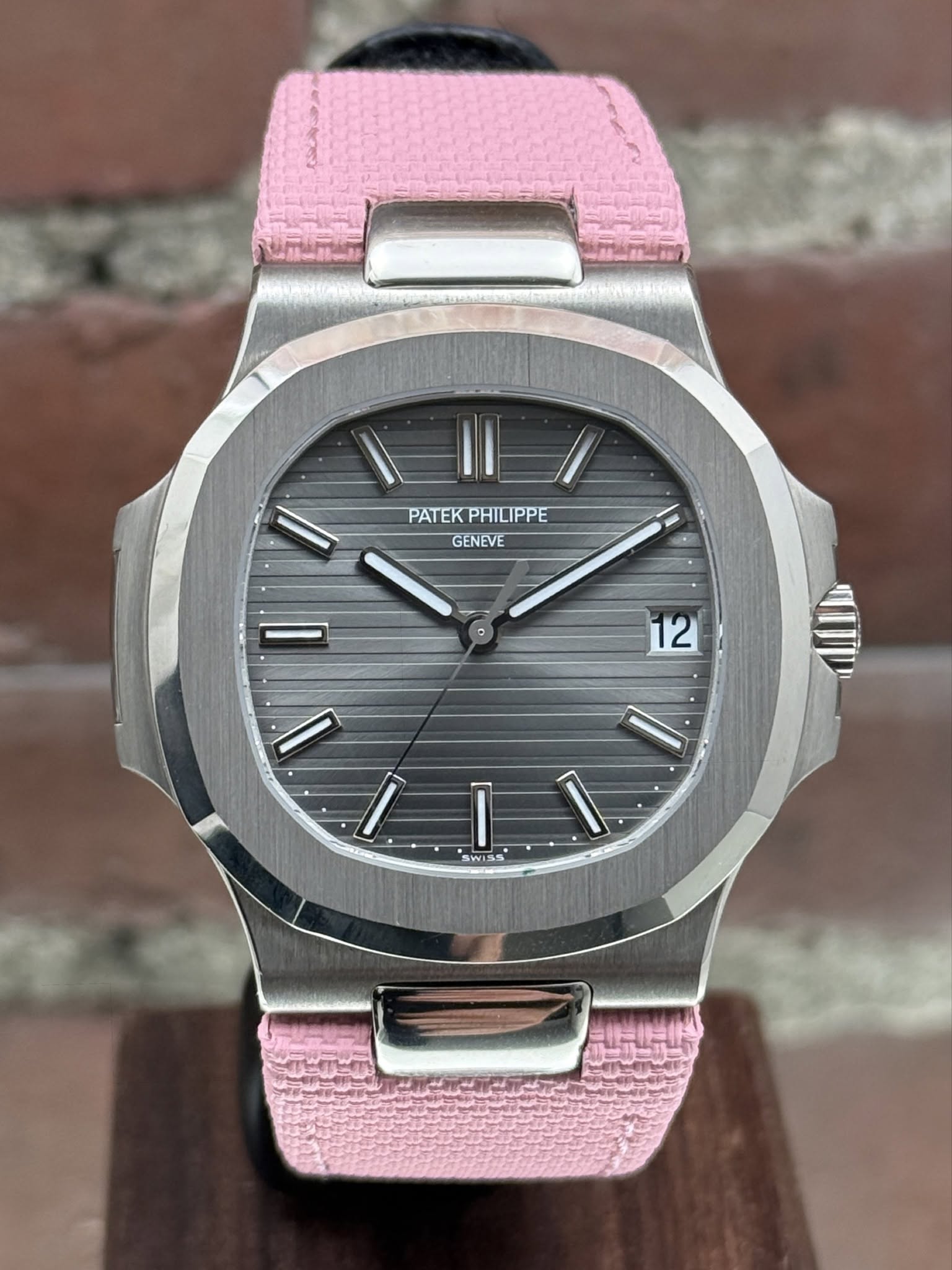 May be an image of wrist watch and text that says 'PATEKPHILIPPE PATEK PHILIPPE GENEVE + 12 I I I WISS'