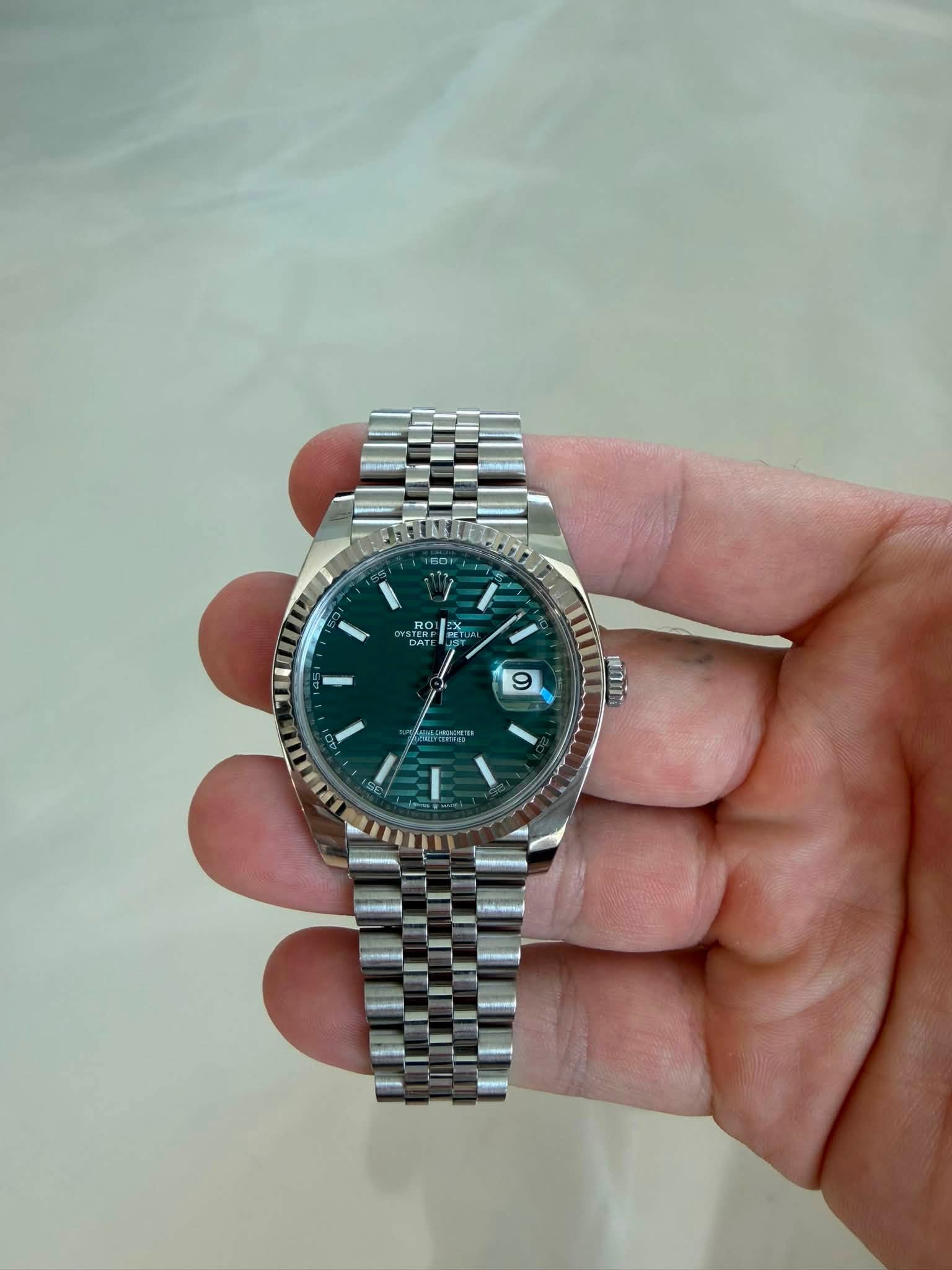 May be an image of wrist watch and text