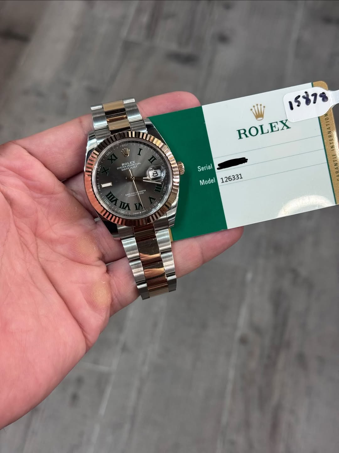 May be an image of wrist watch and text that says 'OT W រត1ះ ROLEX ROLEUS AaT Se Serial 01 LEU መይይ Model 126331 ا O'