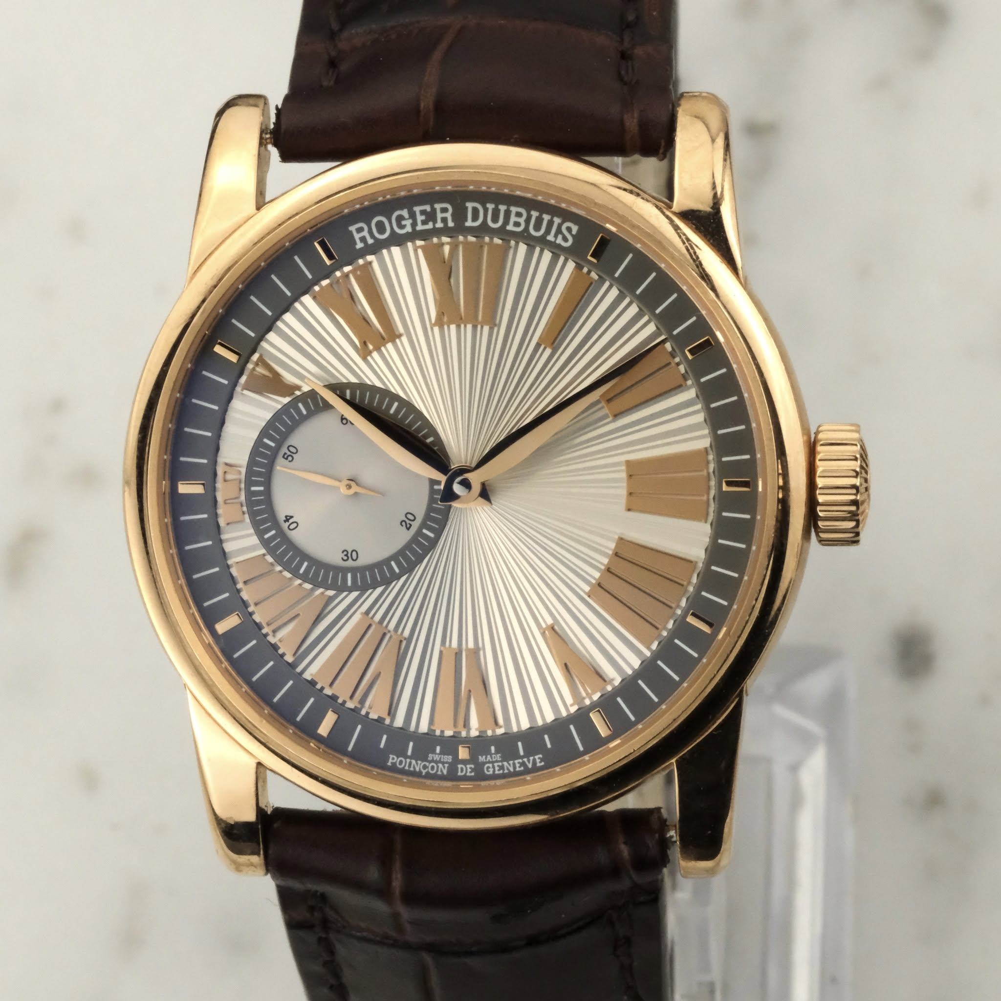 May be an image of wrist watch and text that says 'ROGER ROGER DUBUIS 11 B 50 50 ي 40 20 30 POINÇON DE GENEVE RCTEVE MRDE'