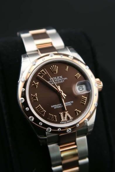May be an image of wrist watch and text that says 'ะ CT Vy HOLEX แ PERPET HOLEPETUAL TUAL EJUST M M JUT 6 ONDRRETER SUPERLATIA RIFUO OEFICIAL V A 2'