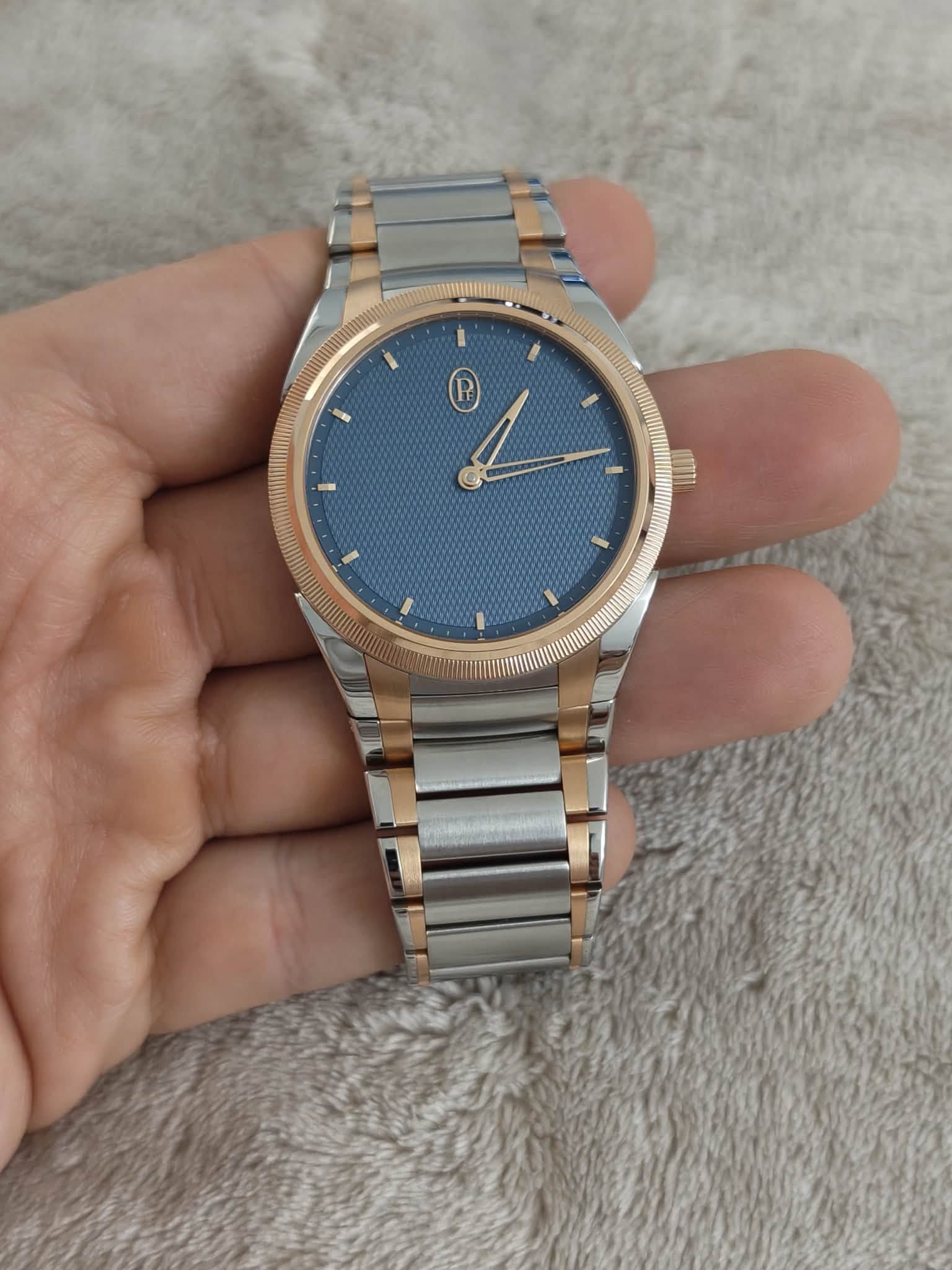 May be an image of wrist watch and text